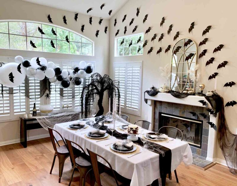 dining room decorated with bats and spider webs to look haunted