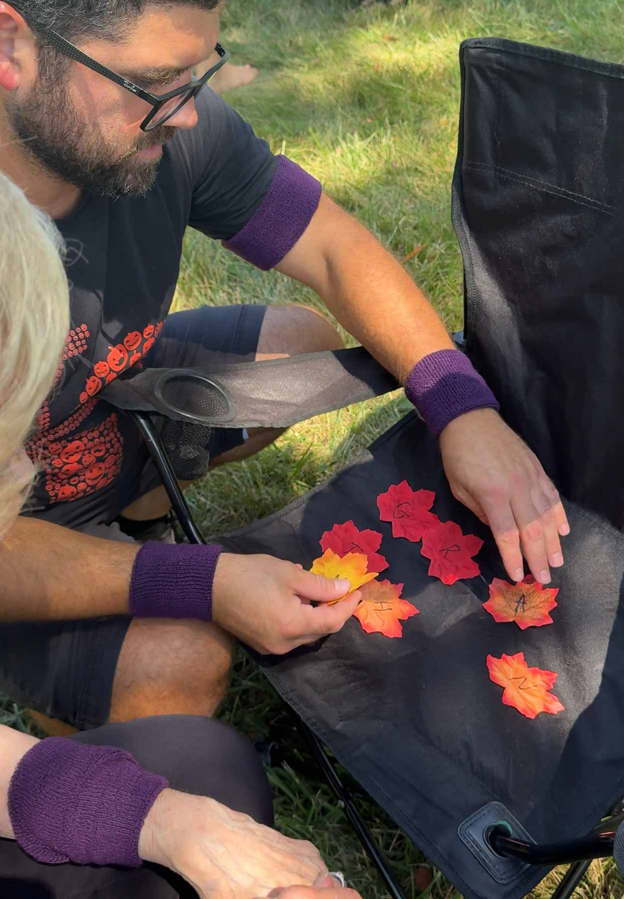 man and grandma unscrambling letters on leaves 