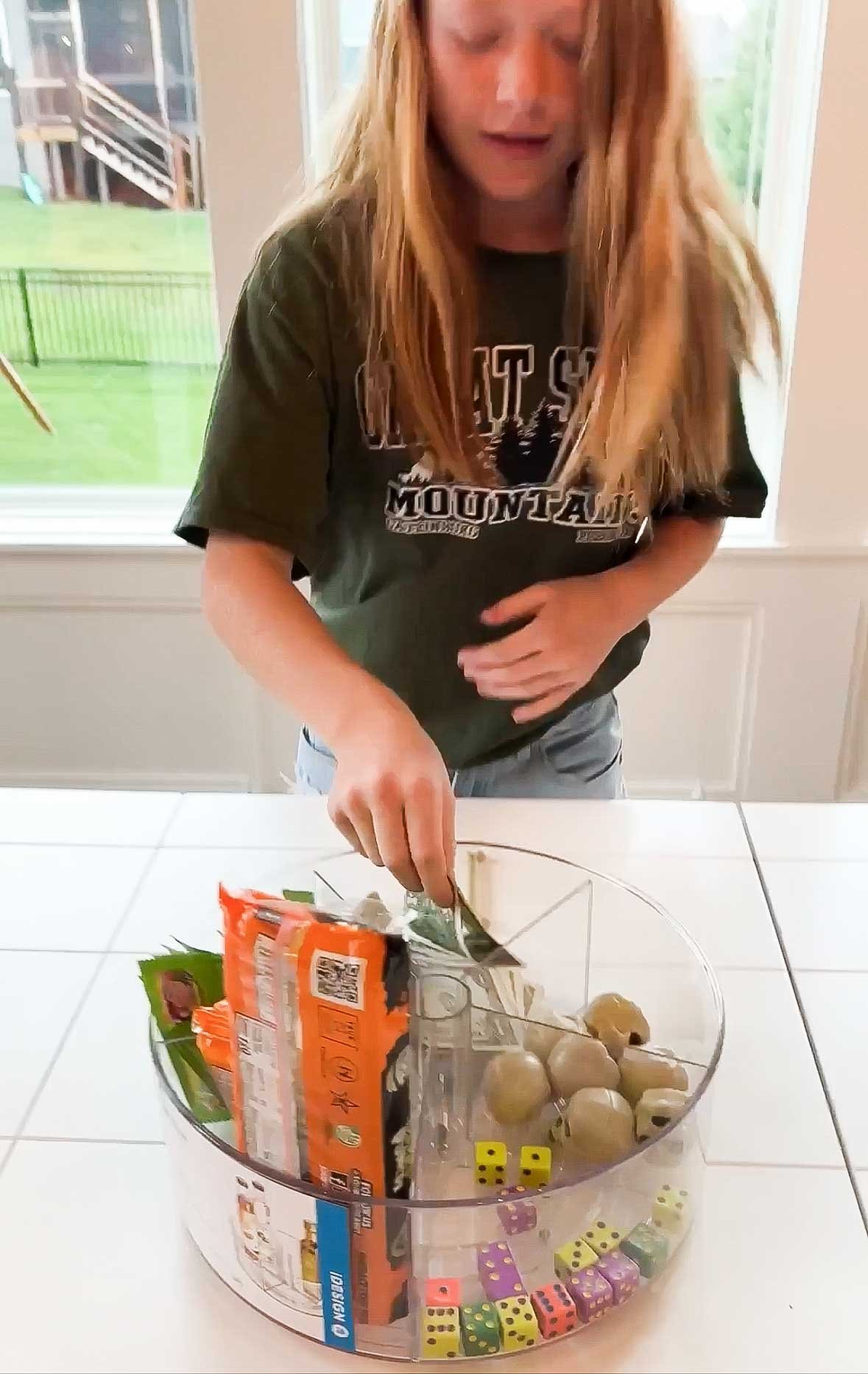 tween girl pulling something out of a lazy susan