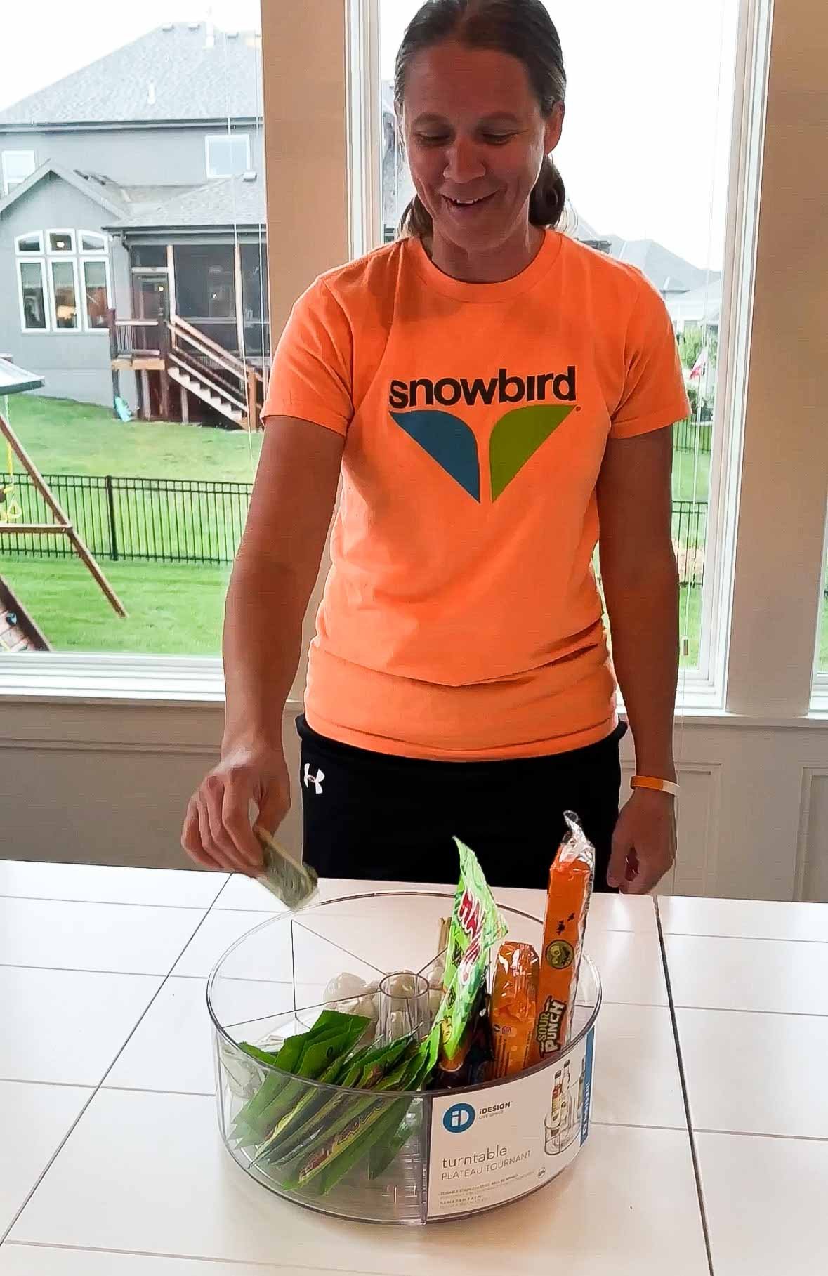 woman putting money into a lazy susan filled with prizes