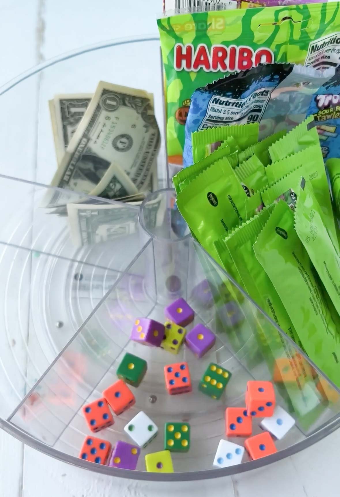 lazy susan with colored dice, candy, and money