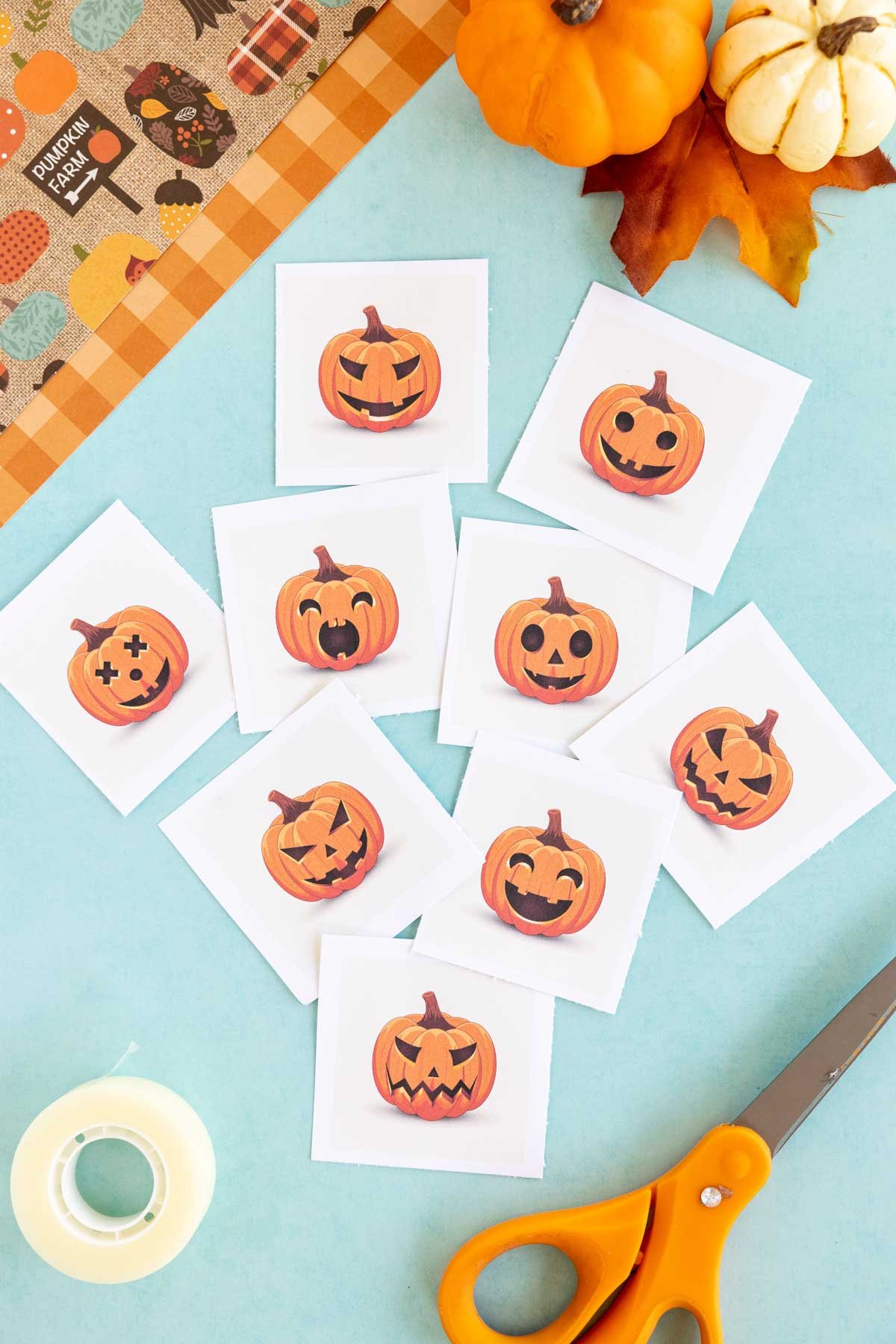 pumpkin cutouts with scissors and tape