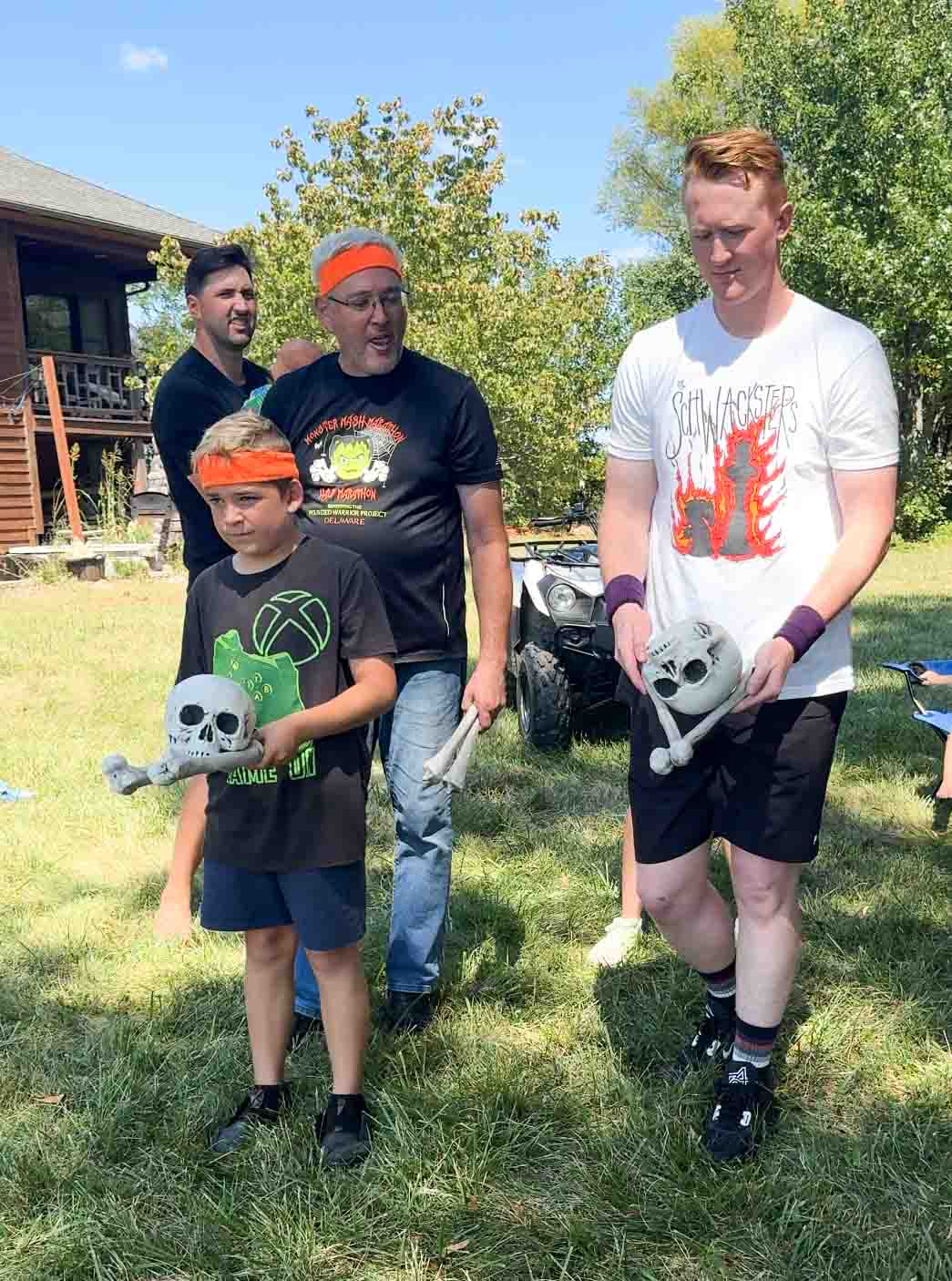 a kid and an adult holding two bones and skulls