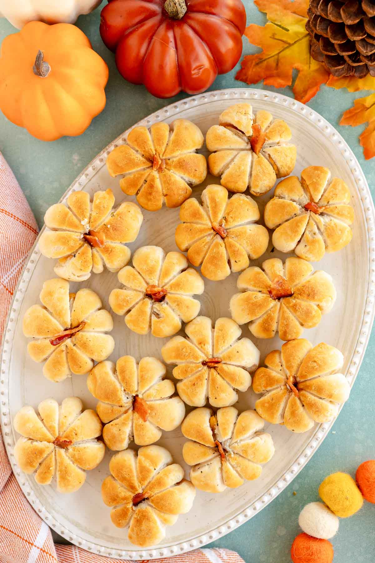 plate full of pumpkin shaped rolls