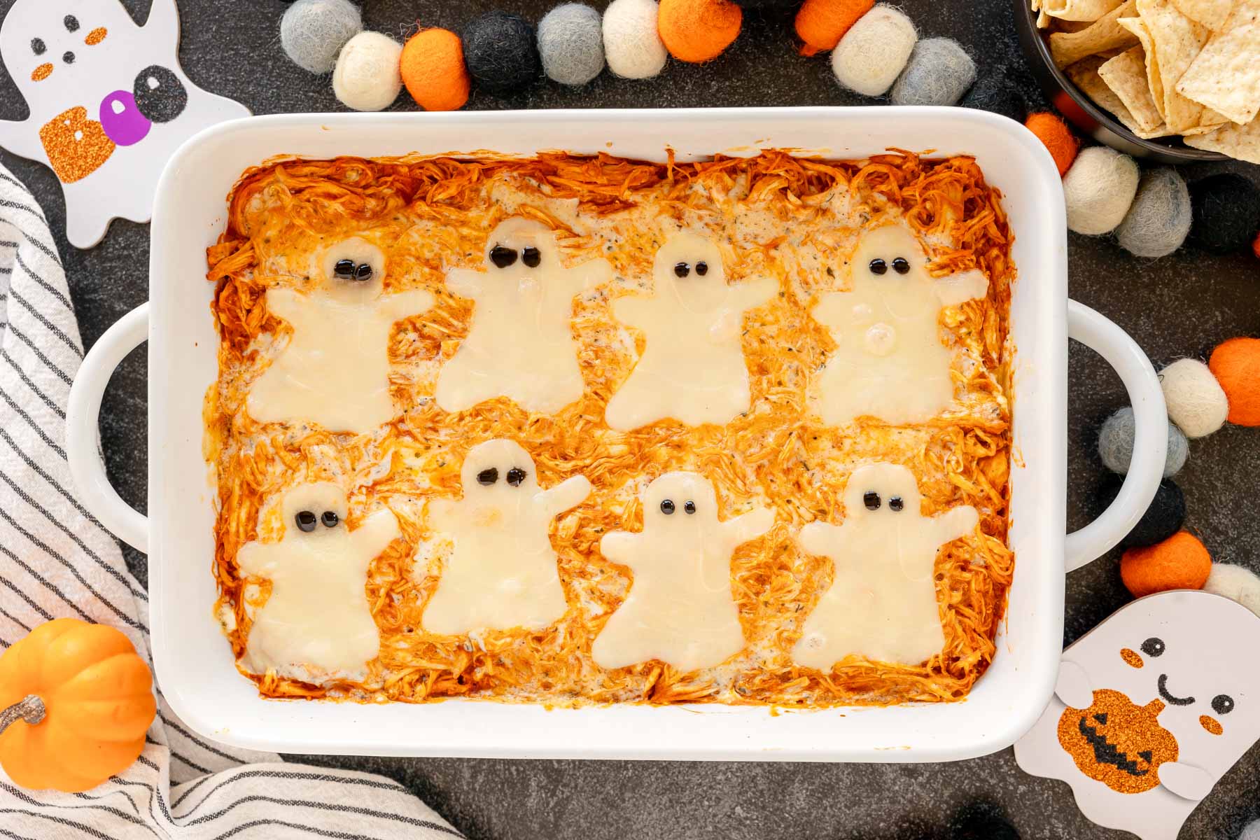 Halloween buffalo chicken dip in a white baking dish