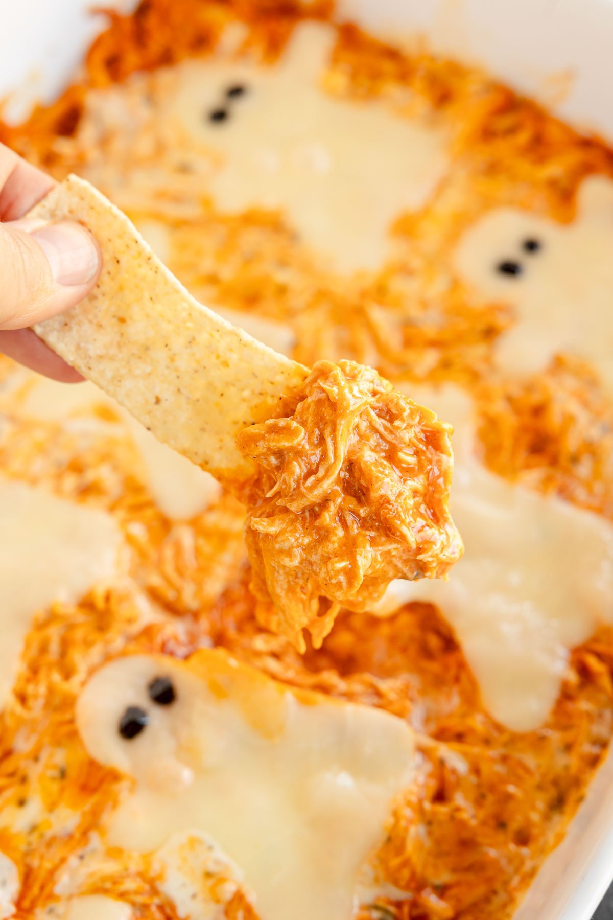 chip dipped into Halloween buffalo chicken dip