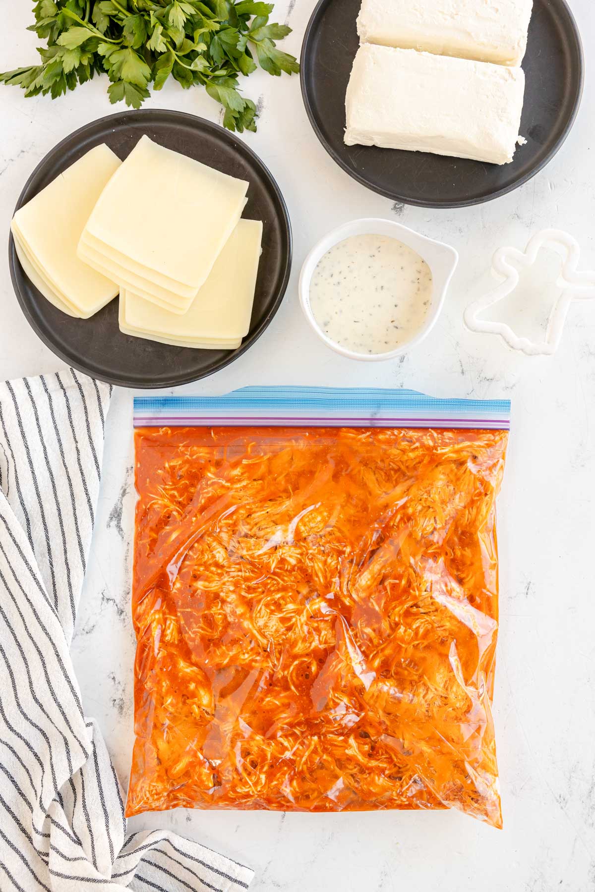 shredded chicken and buffalo sauce in a ziploc bag