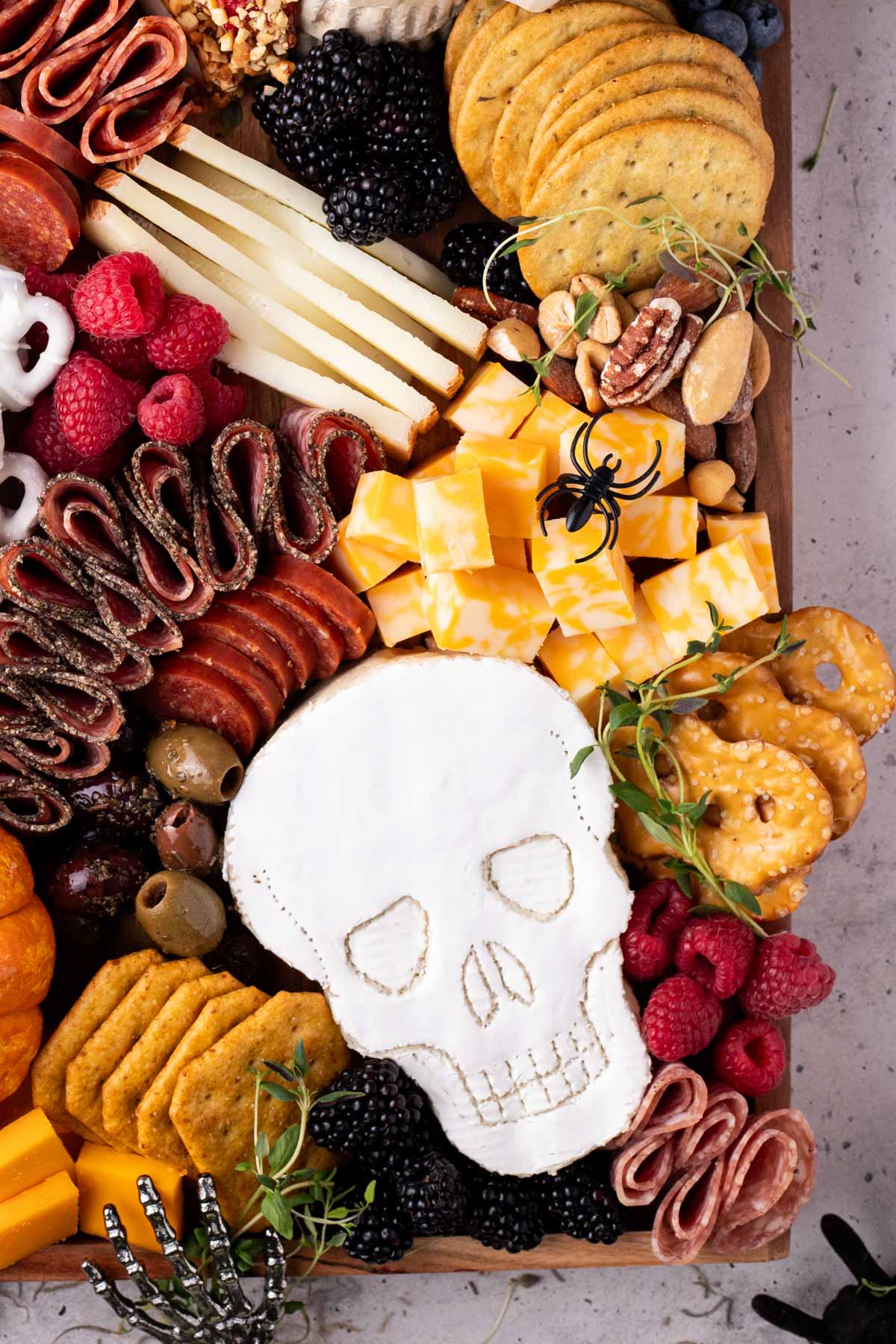 Halloween charcuterie board with a skull made out of brie