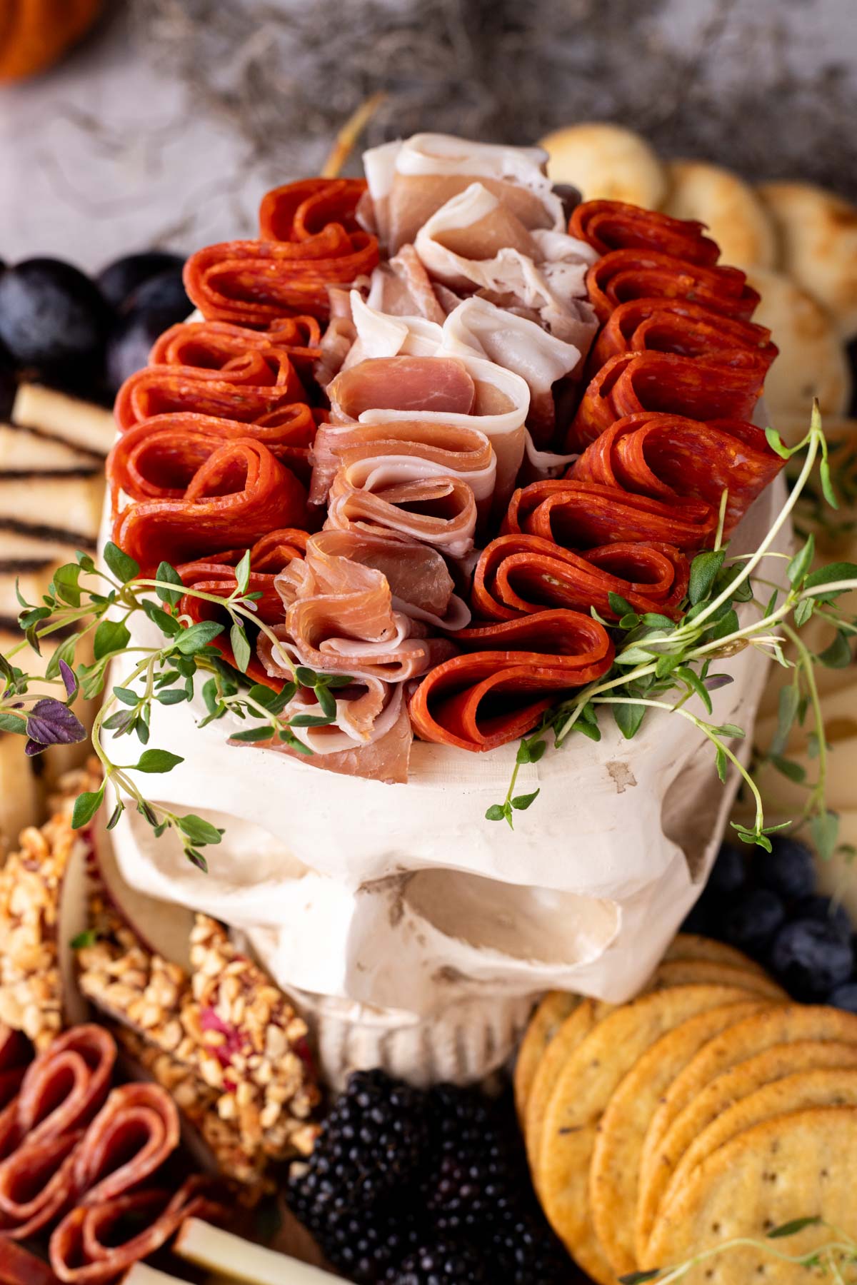 skull filled with charcuterie meats on a Halloween charcuterie board