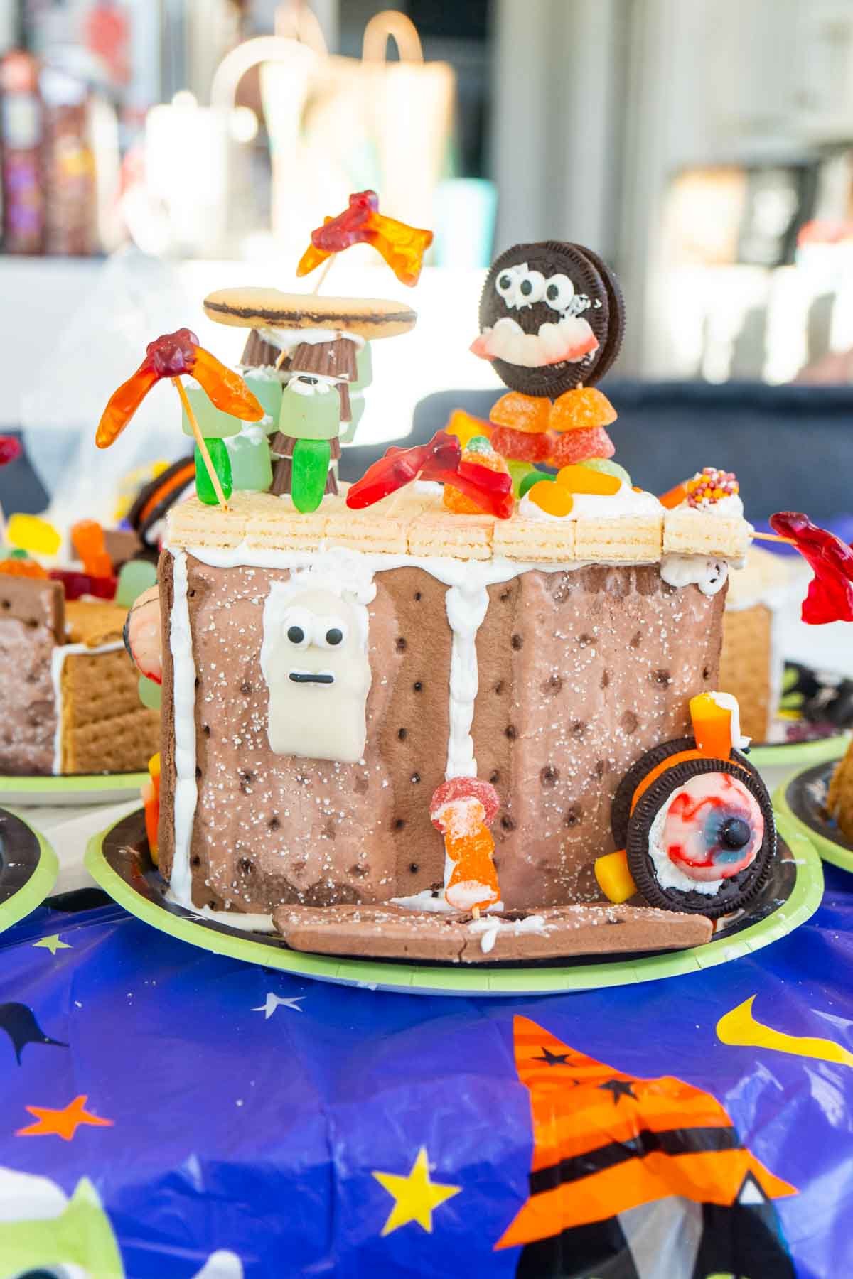 Halloween gingerbread house topped with Halloween candy