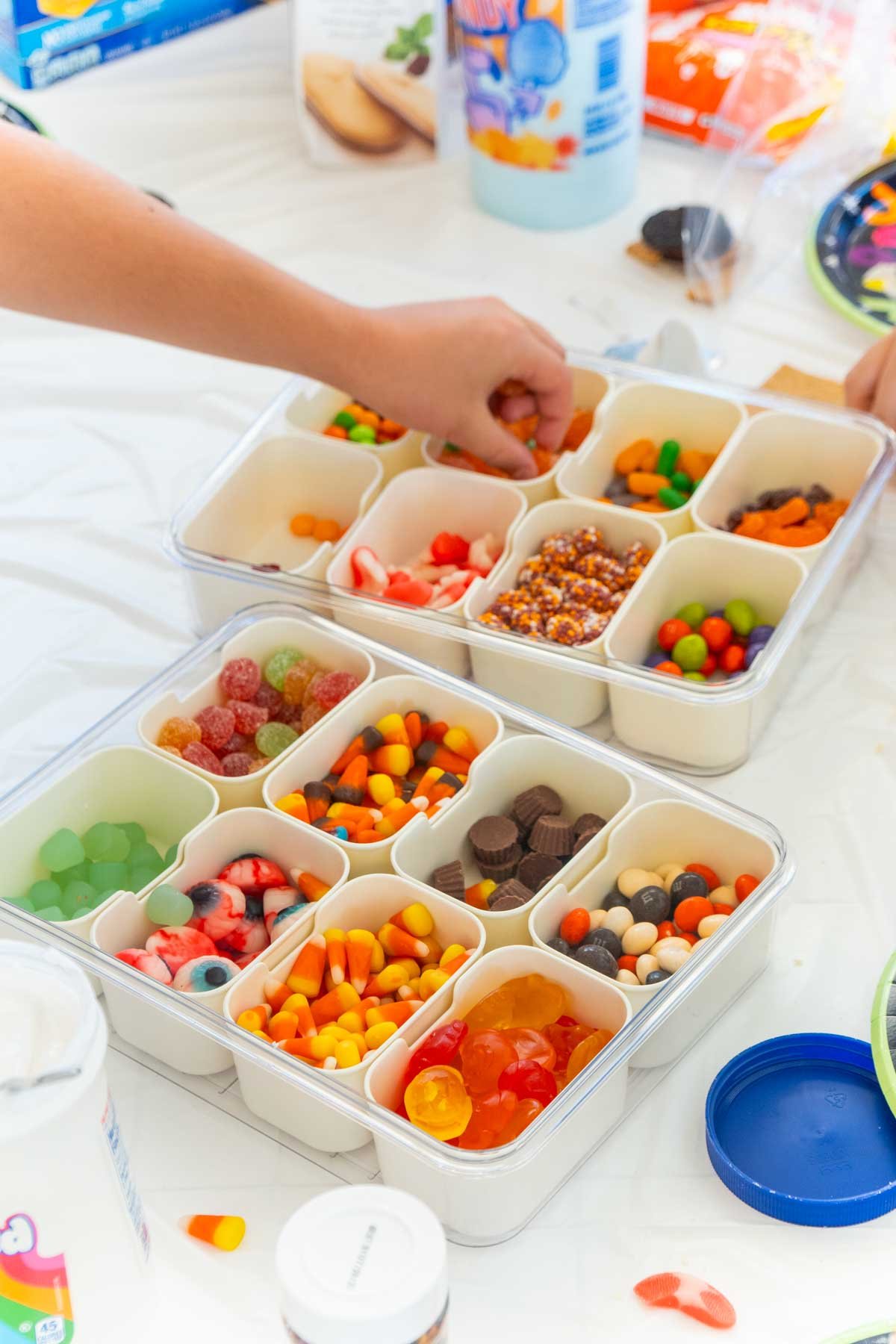 hand grabbing candies out of a snackle box