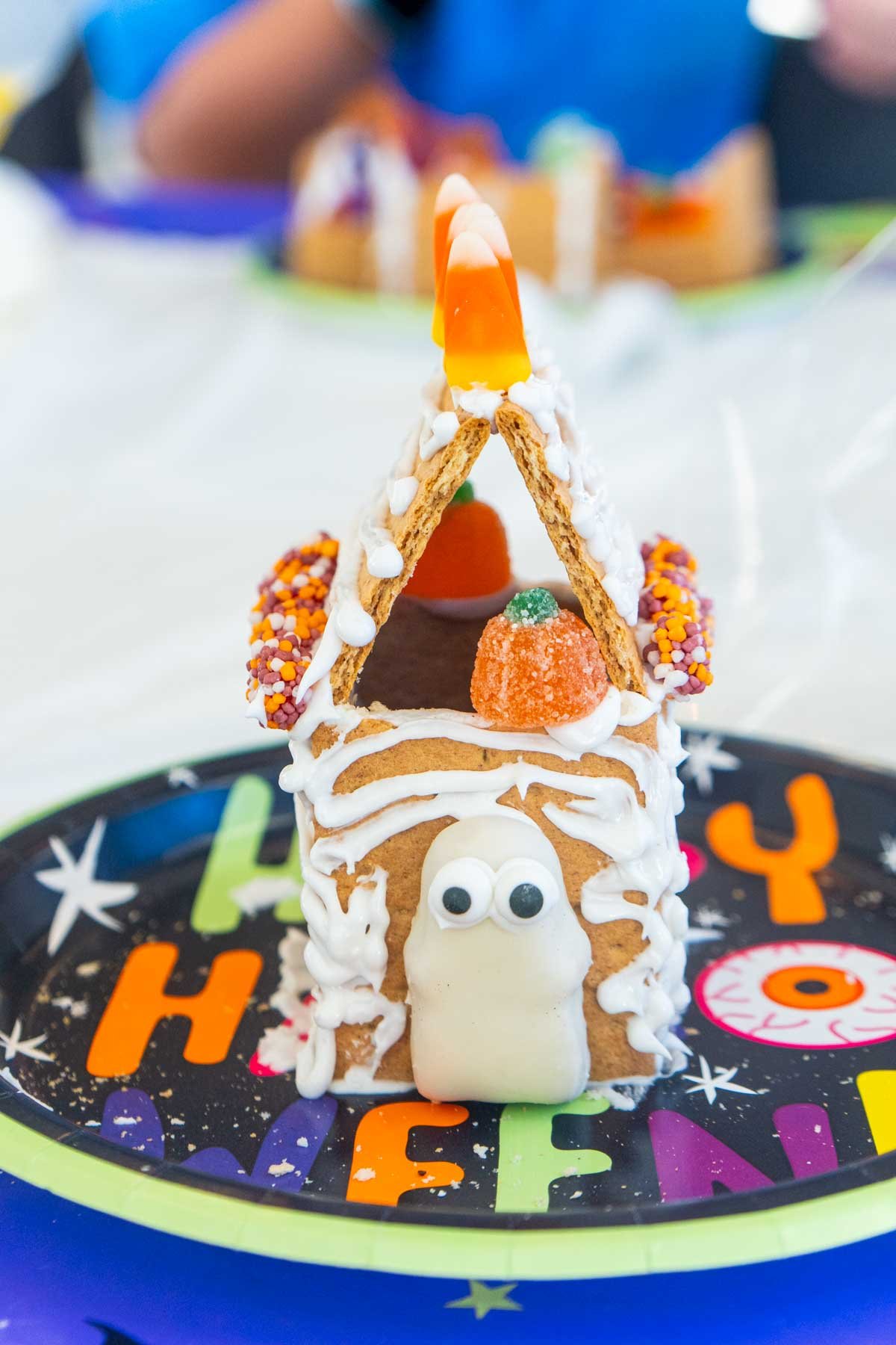 a little Halloween gingerbread house on the paper plate