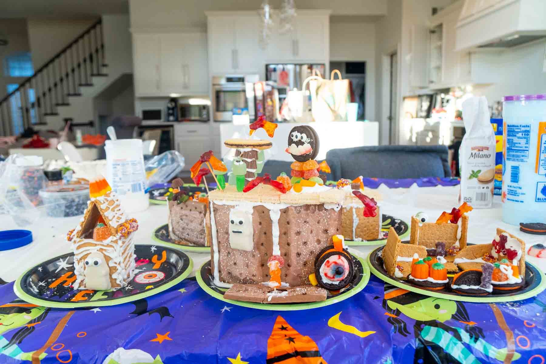 a bunch of Halloween gingerbread houses on a table 