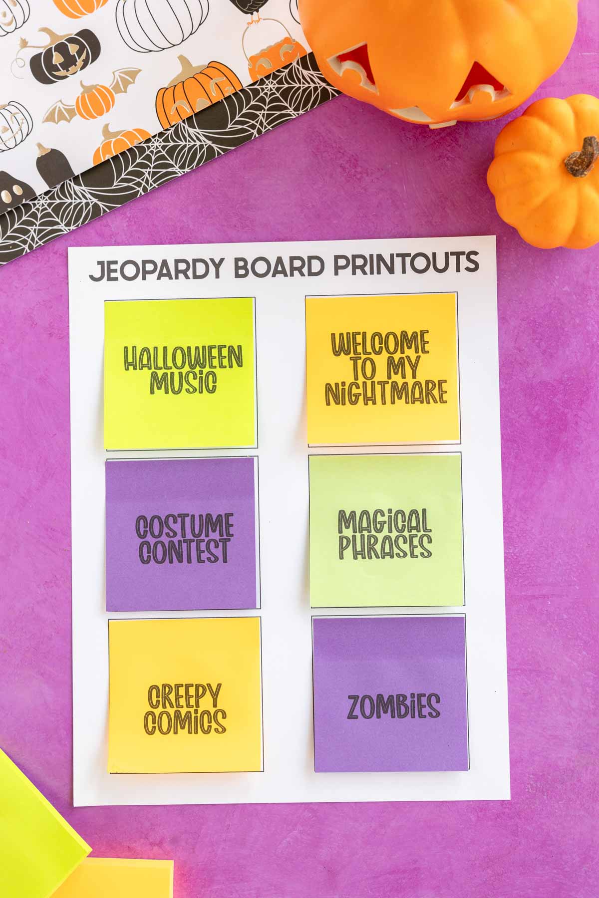 post-it notes on a white paper with Halloween Jeopardy categories written on them