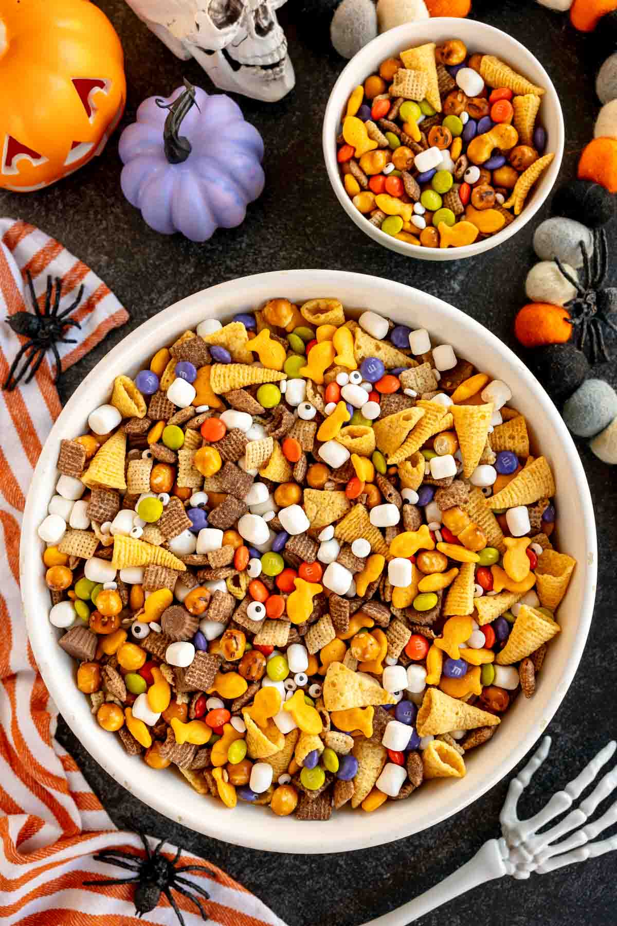 bowl of Halloween snack mix with a small bowl behind it