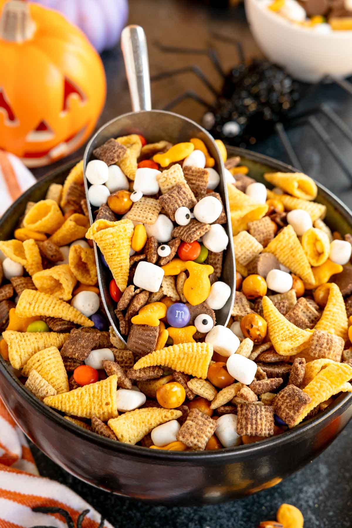 scoop in a Halloween snack mix bowl