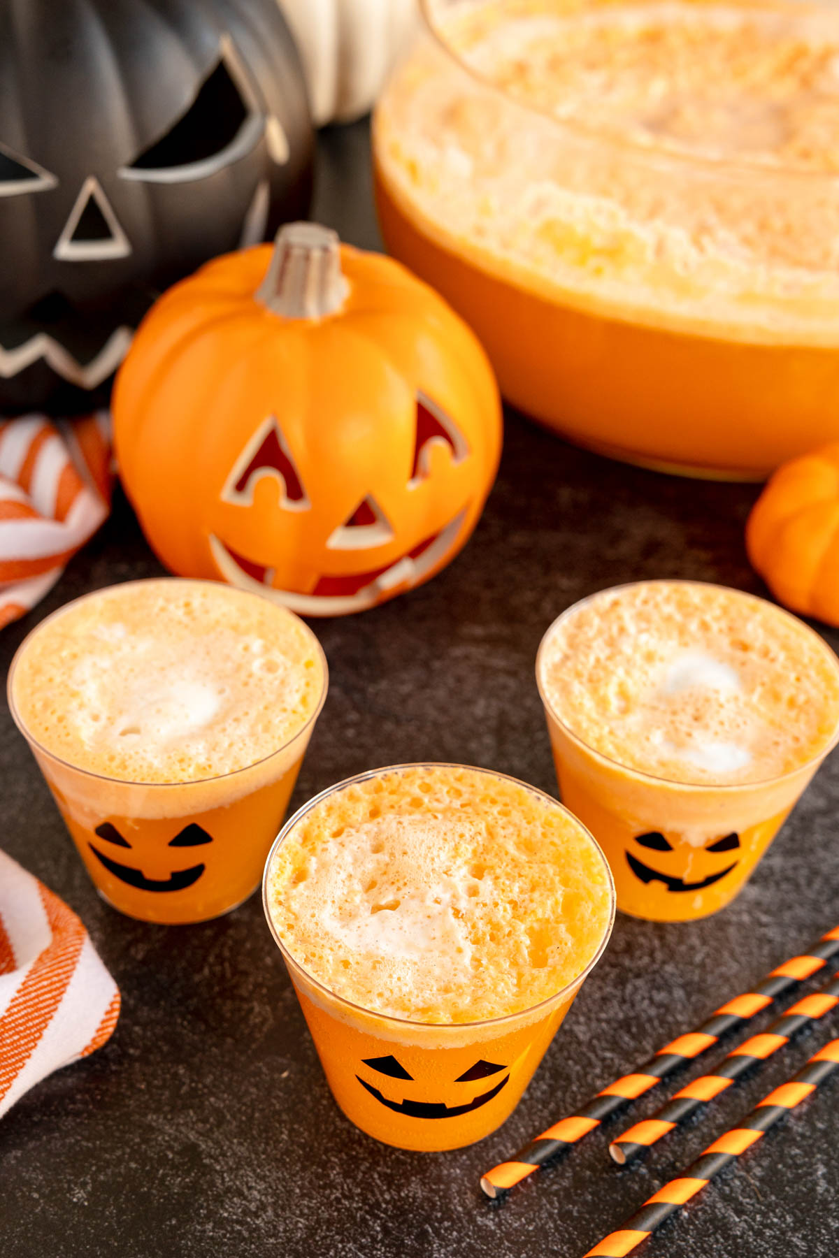 top down view of three glasses of orange pumpkin punch