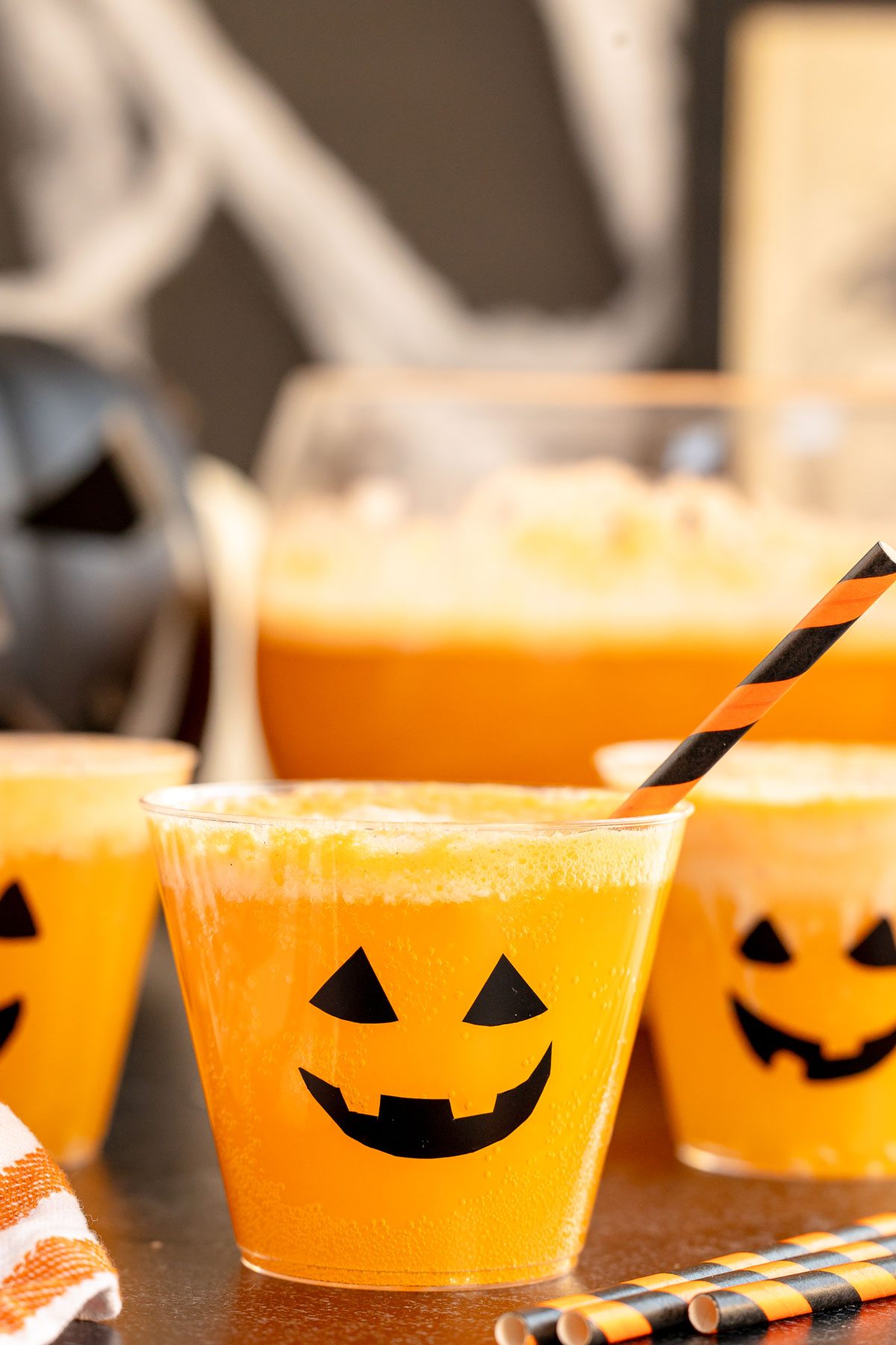 Halloween pumpkin punch in cups that look like jack-o-lanterns 