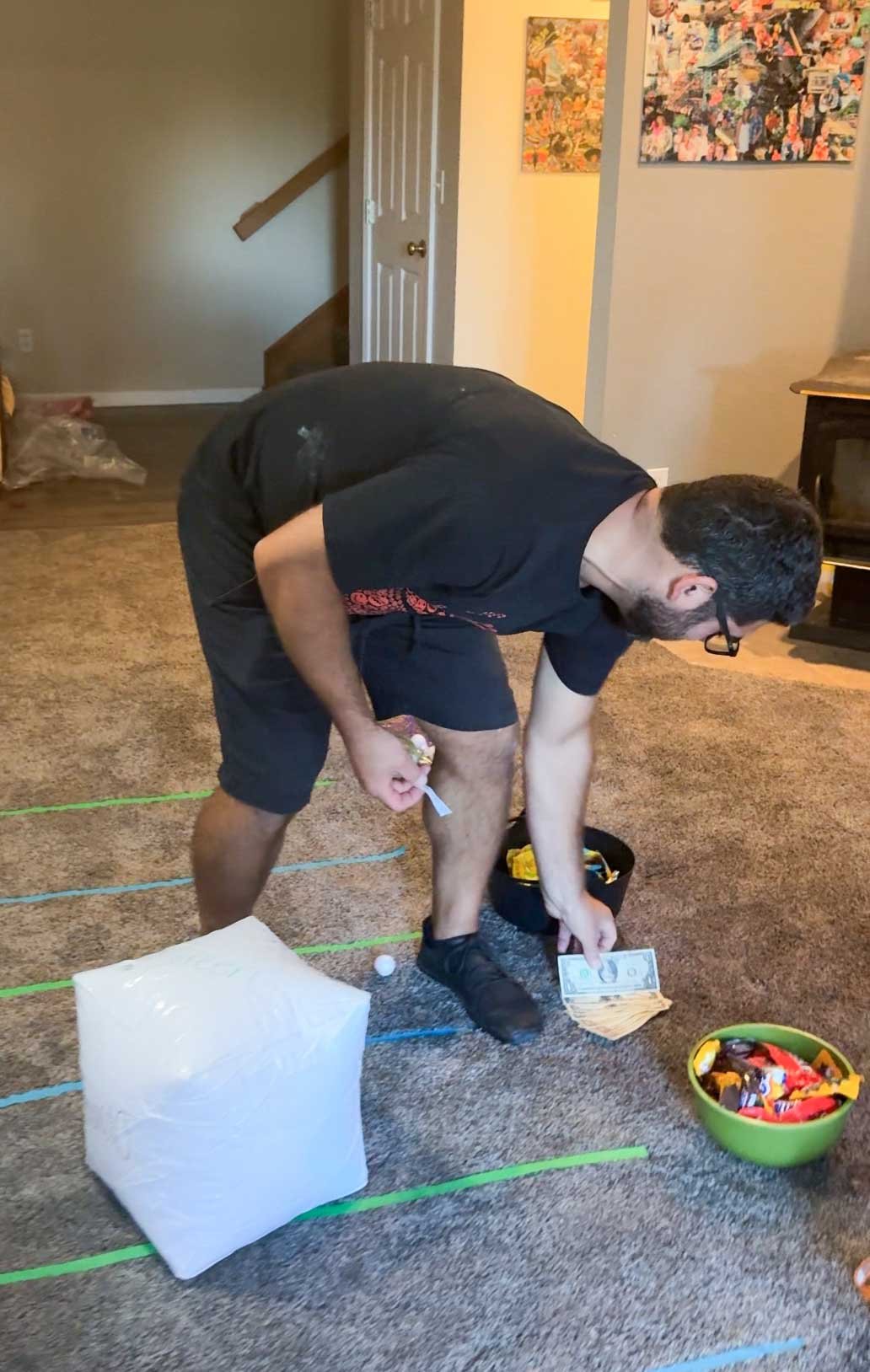 man putting back a prize into a bucket