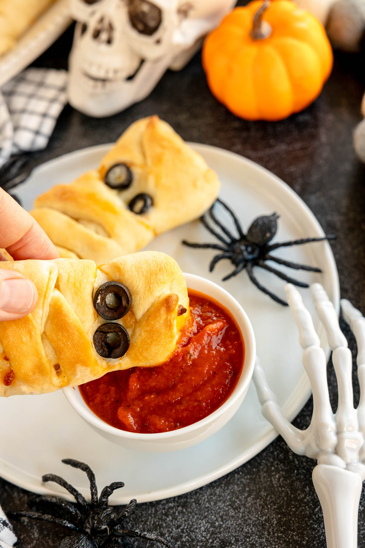 pizza mummy being dipped in pizza sauce