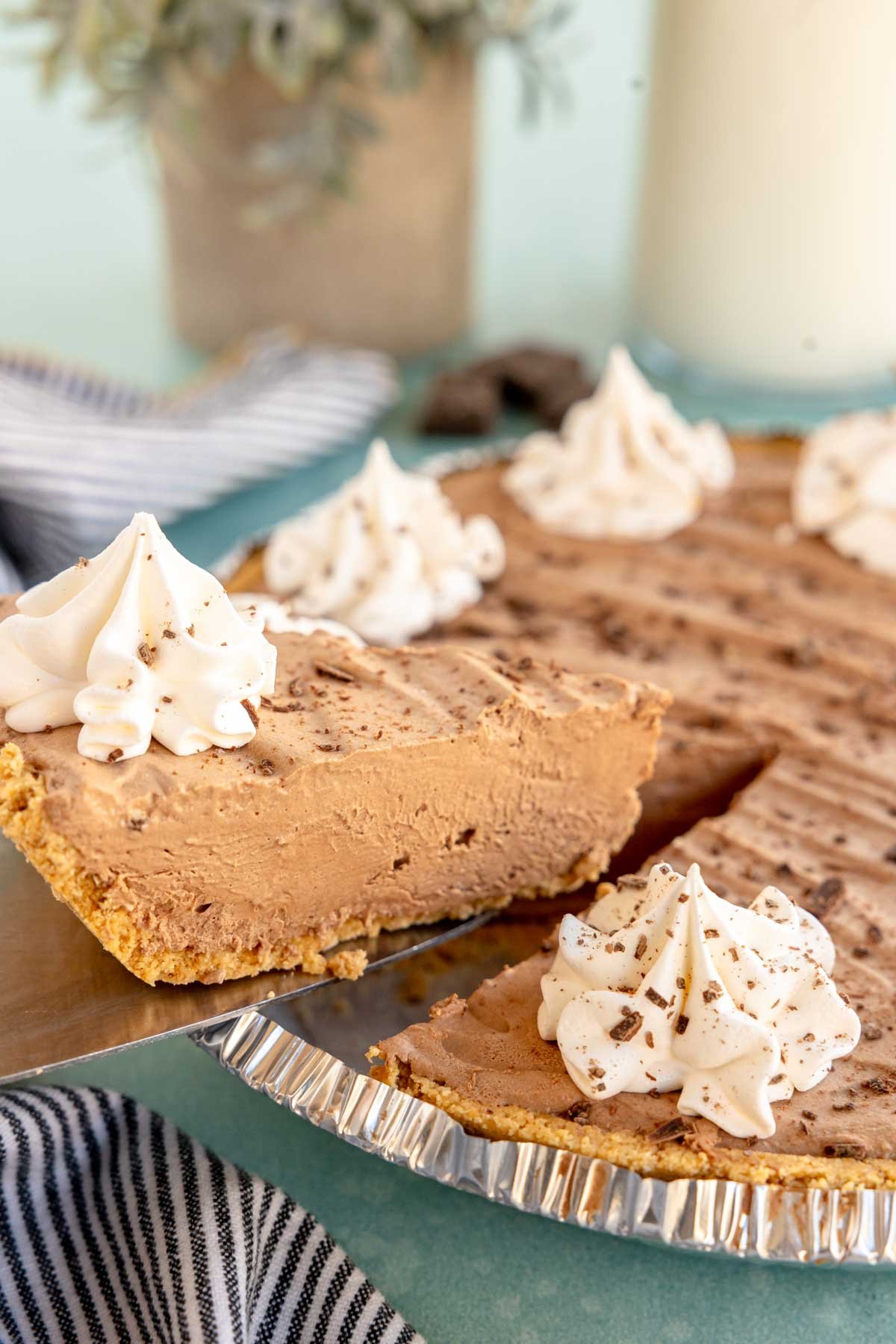 pie slicer pulling a piece of no bake chocolate pie out of a pie