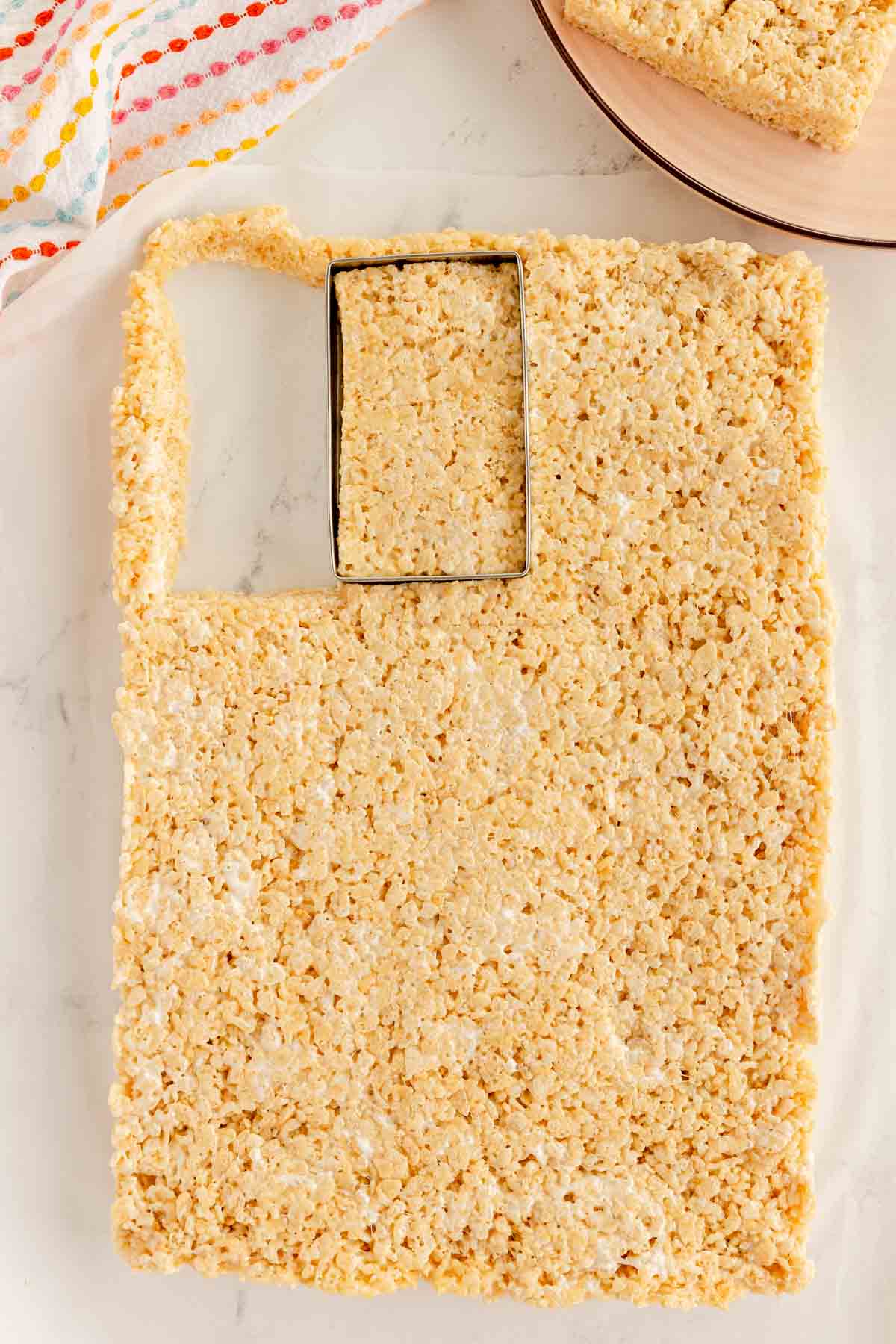 rectangle cookie cutter on a tray of rice krispy treats