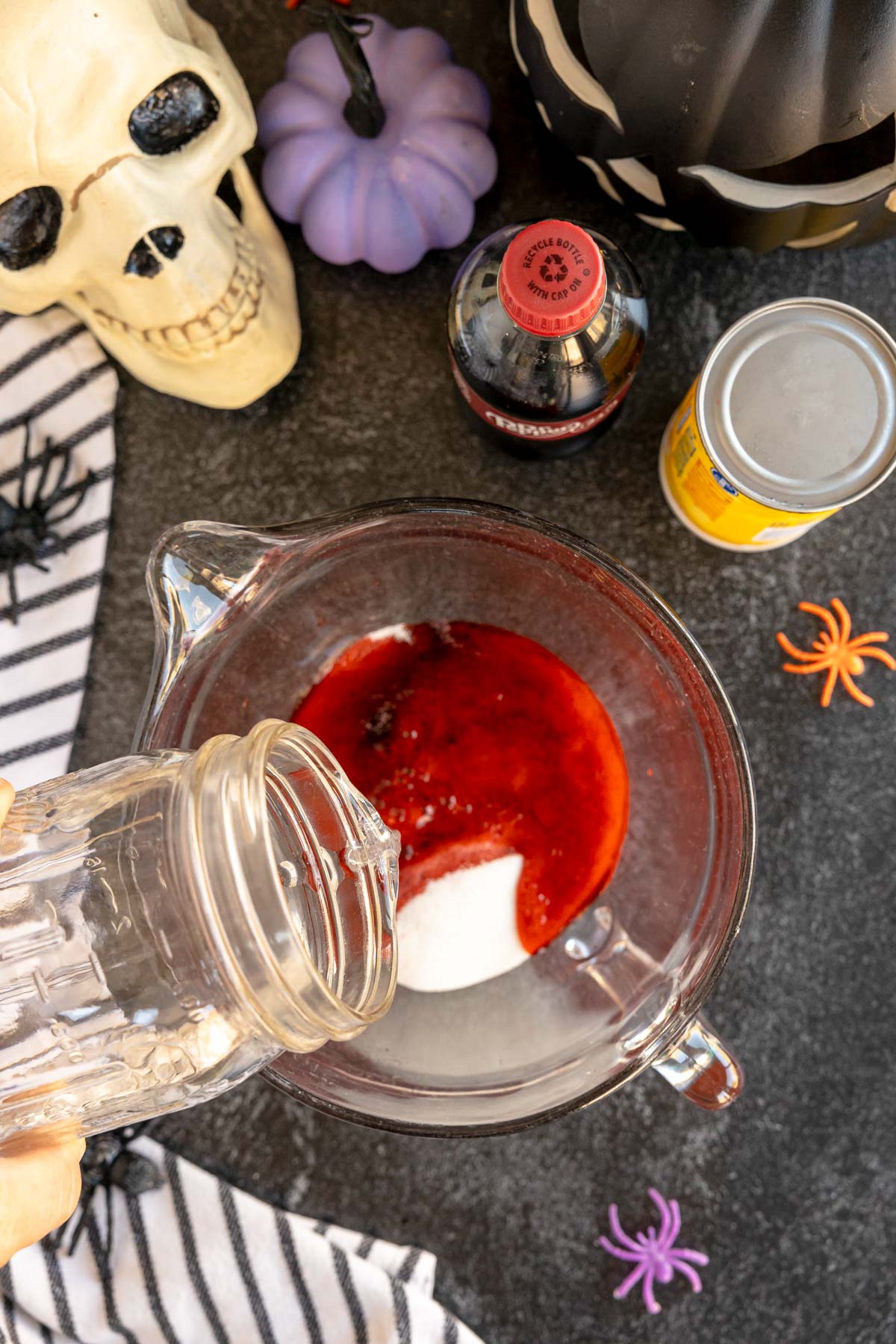 making black cherry kool-aid in a glass pitcher