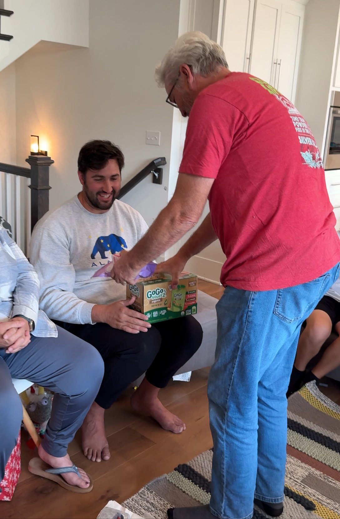 man swapping a box of applesauce for a gift