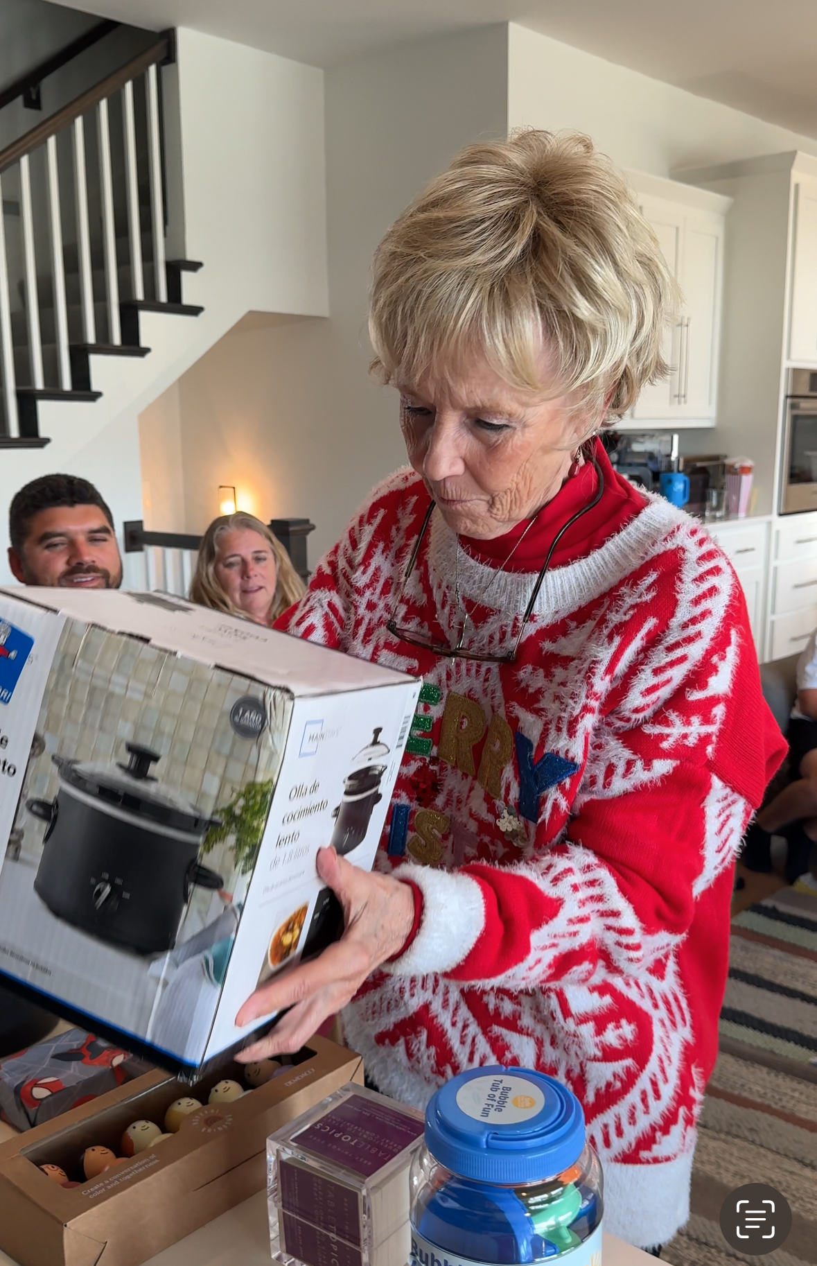 woman picking up a crockpot from a table