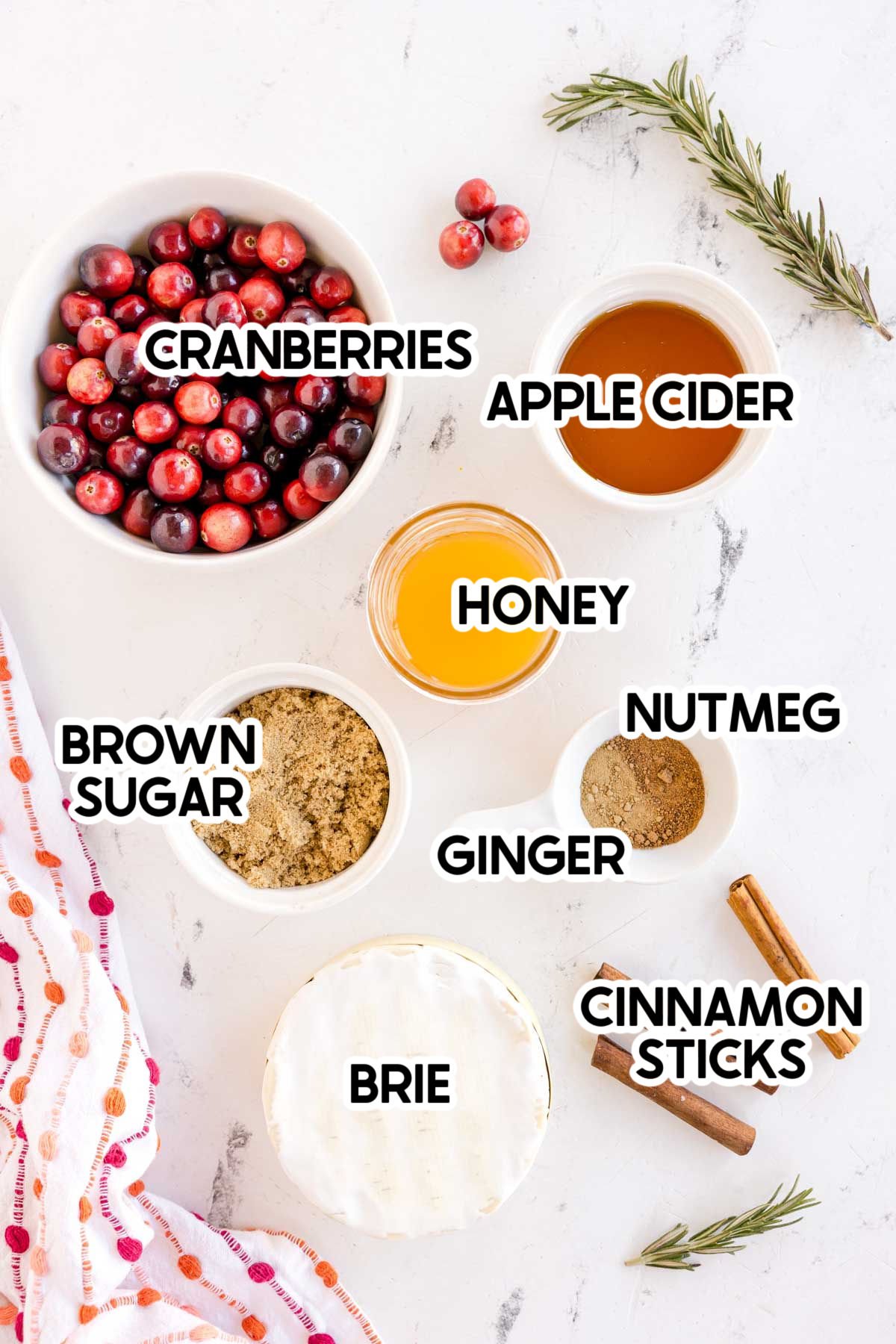 ingredients to make a baked brie with honey with labels on top