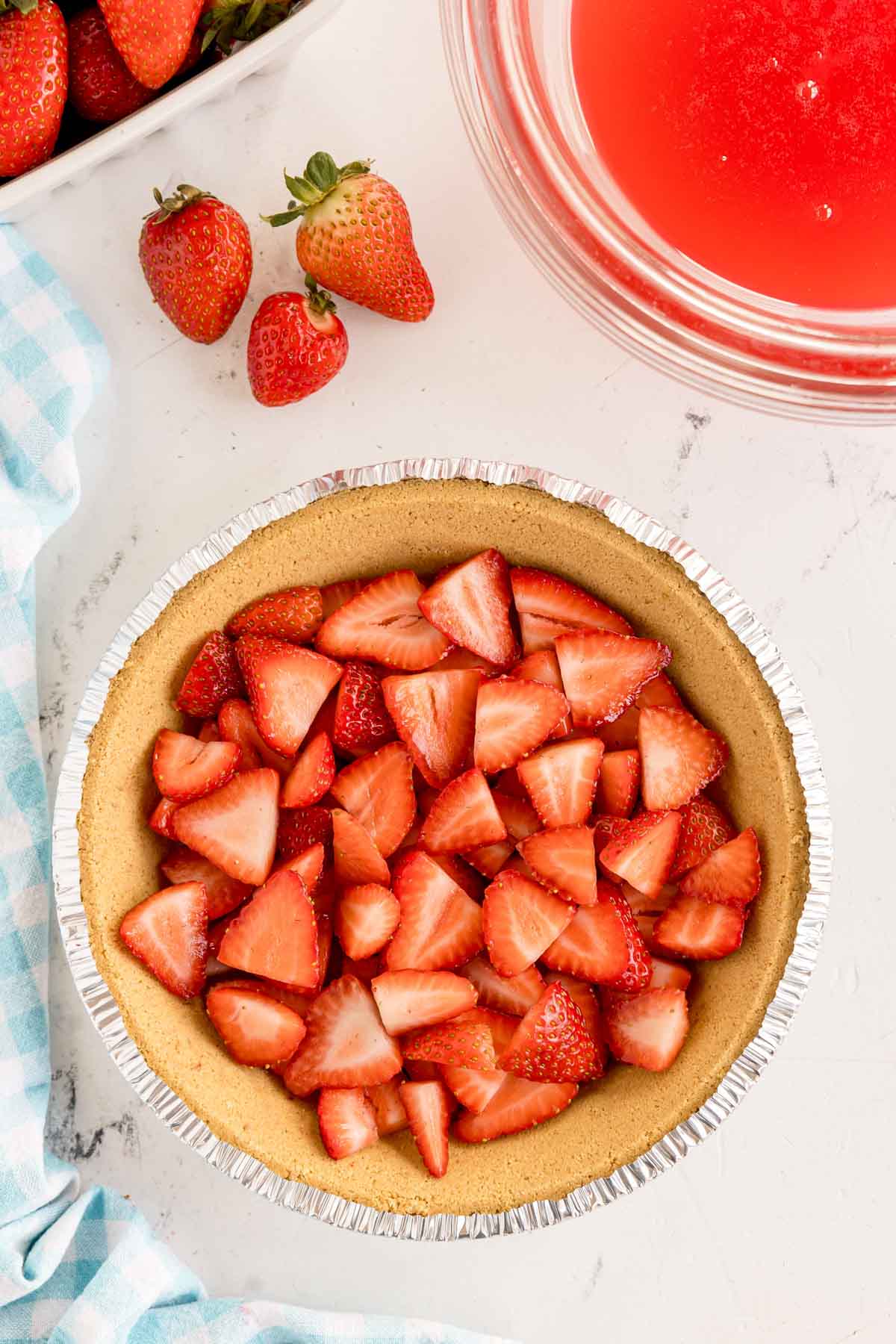 sliced strawberries in a graham cracker pie crust