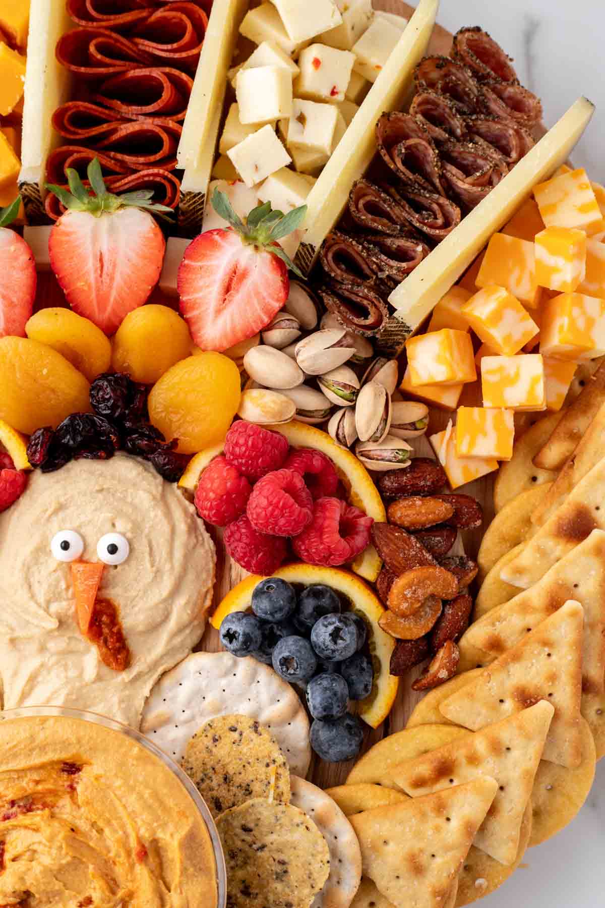 close up image of a Thanksgiving charcuterie board with cheese and berries 