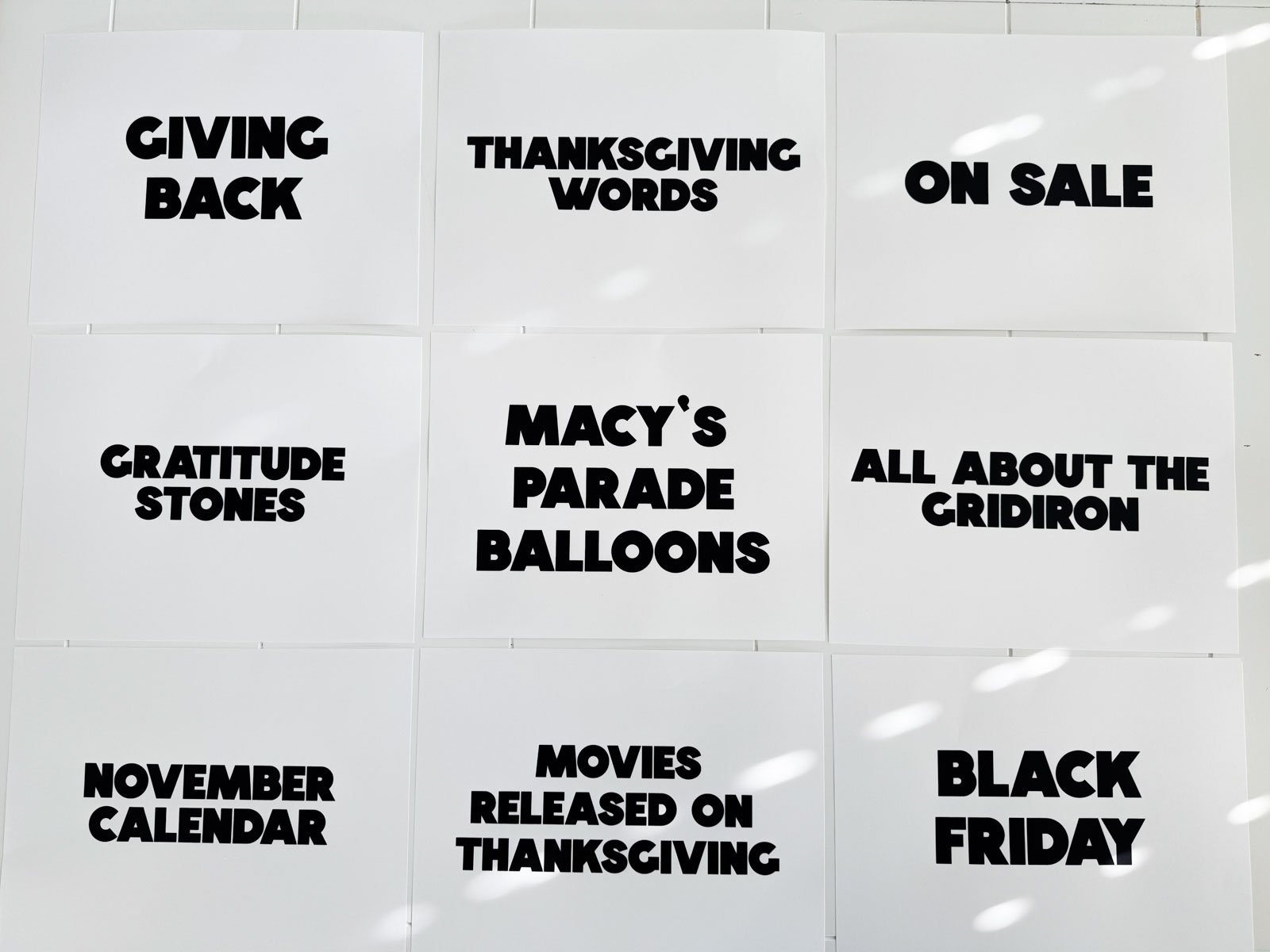 Thanksgiving categories on pieces of paper on a white table