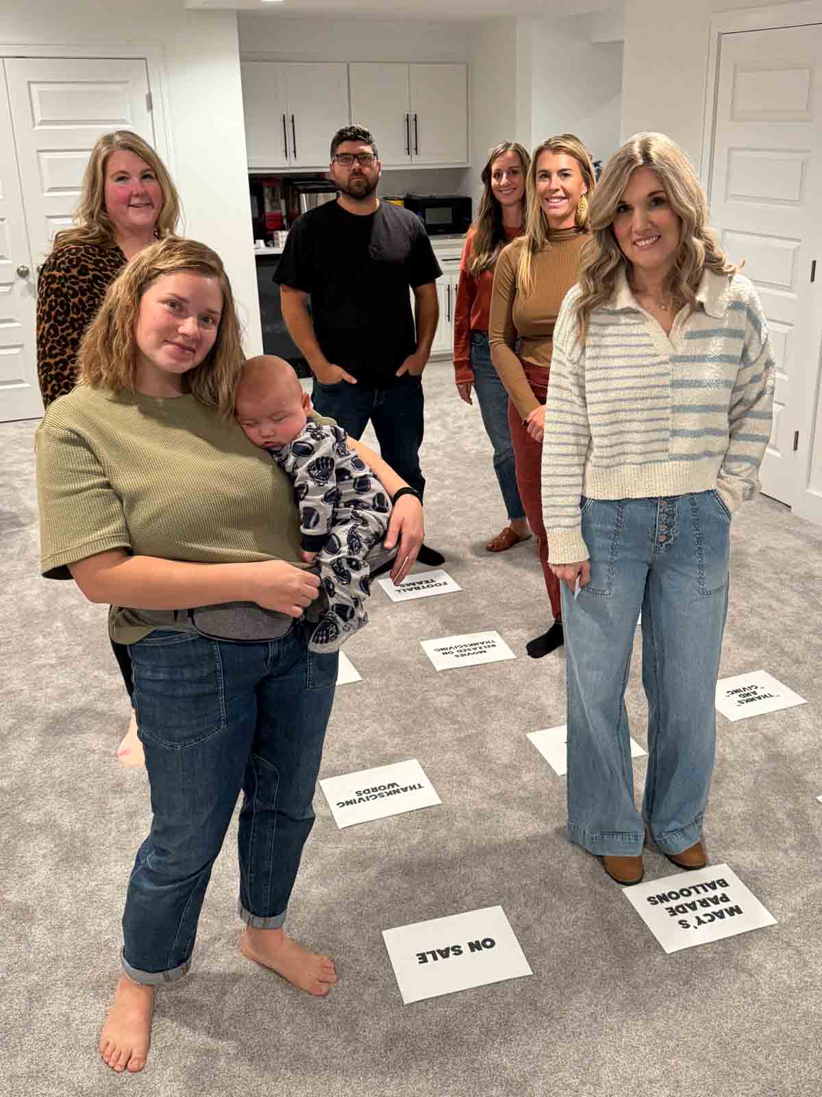 people standing near white pieces of paper on a floor