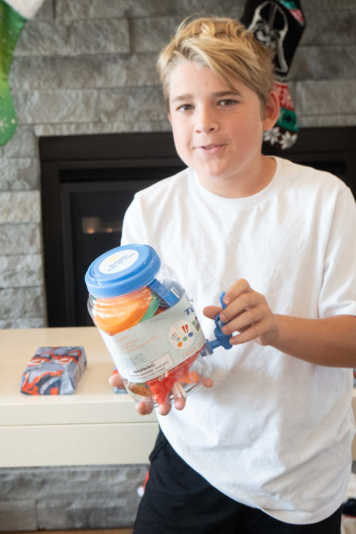 boy holding a bucket of bubbles