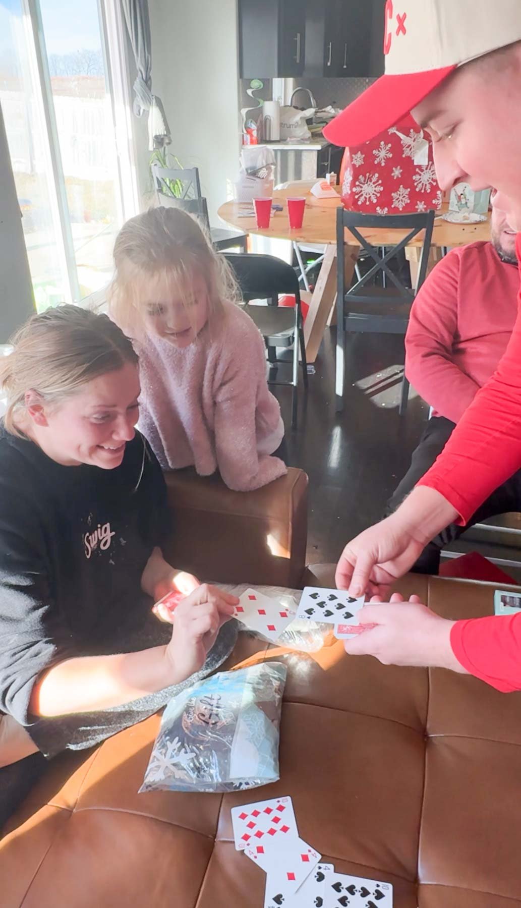 a man and a woman playing a game of war with cards in their hands