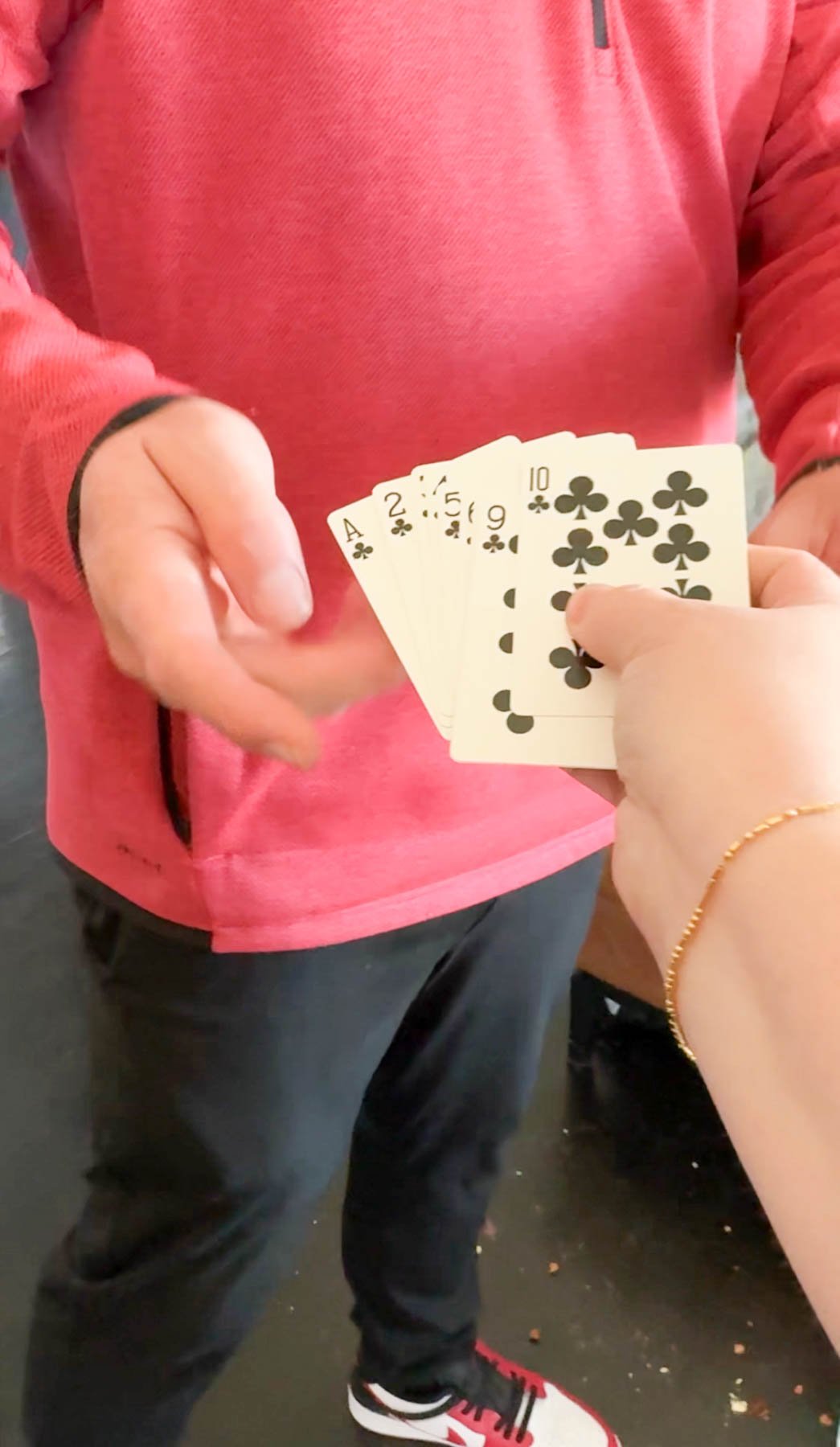 woman handing playing cards to a man