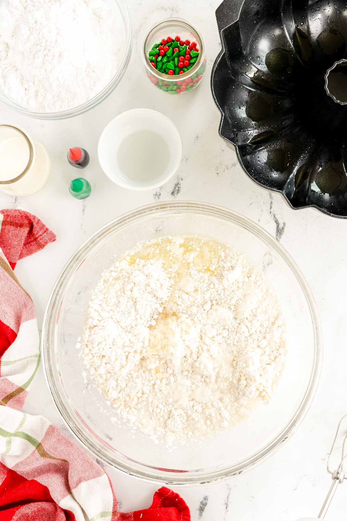 glass bowl with white cake mix 