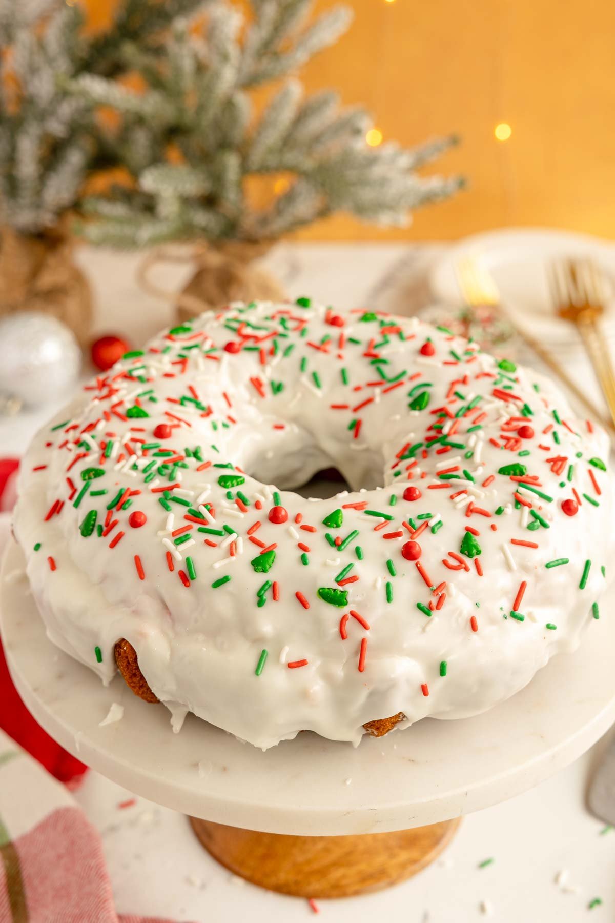 Christmas bundt cake with Christmas sprinkles on a cake stand