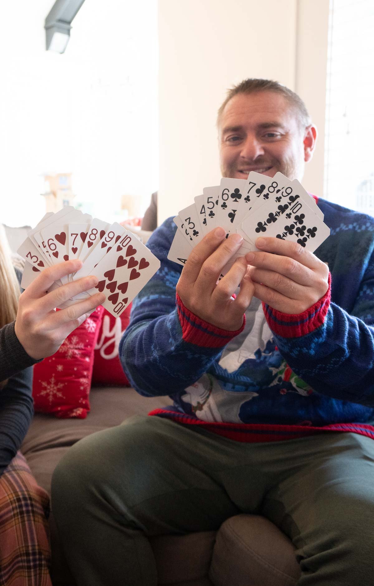 man holding up playing cards 