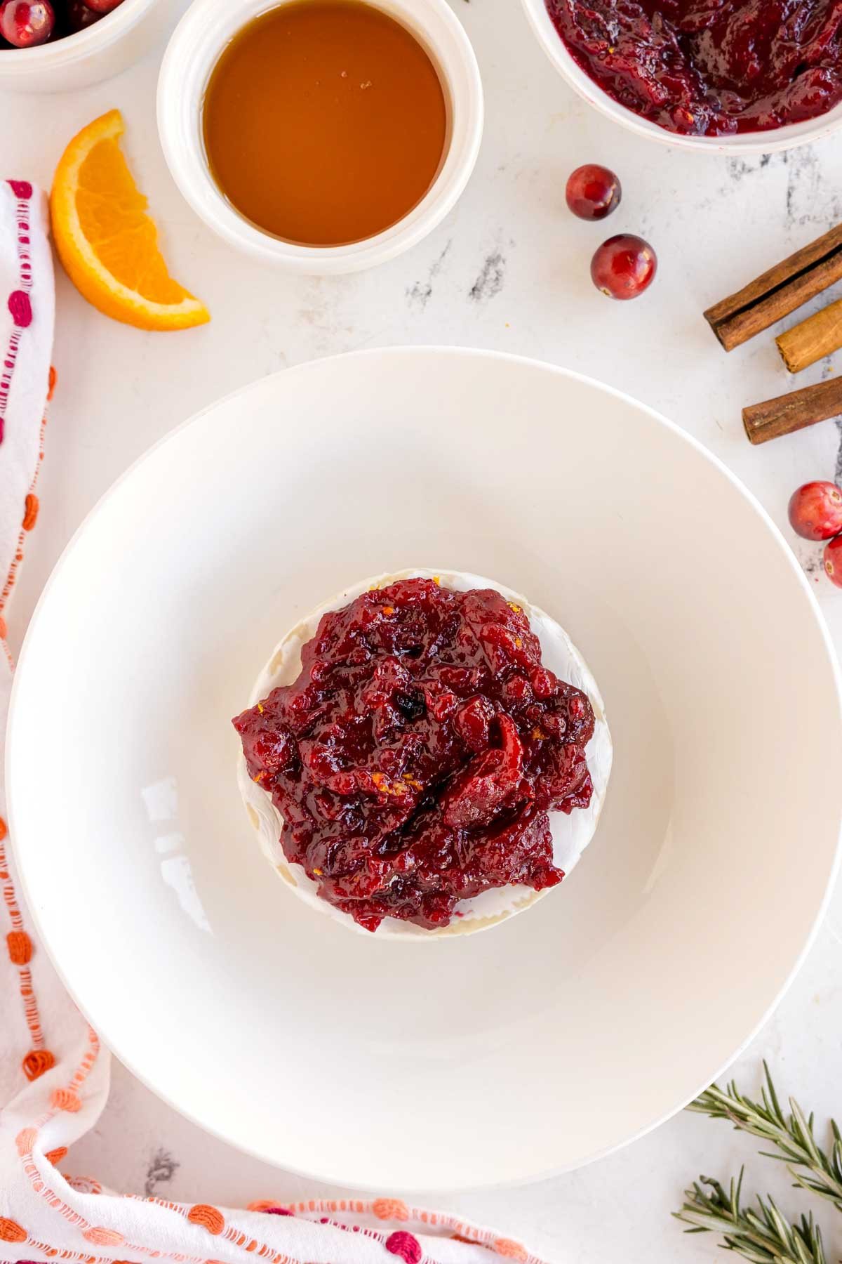 brie with cranberry sauce in a white dish