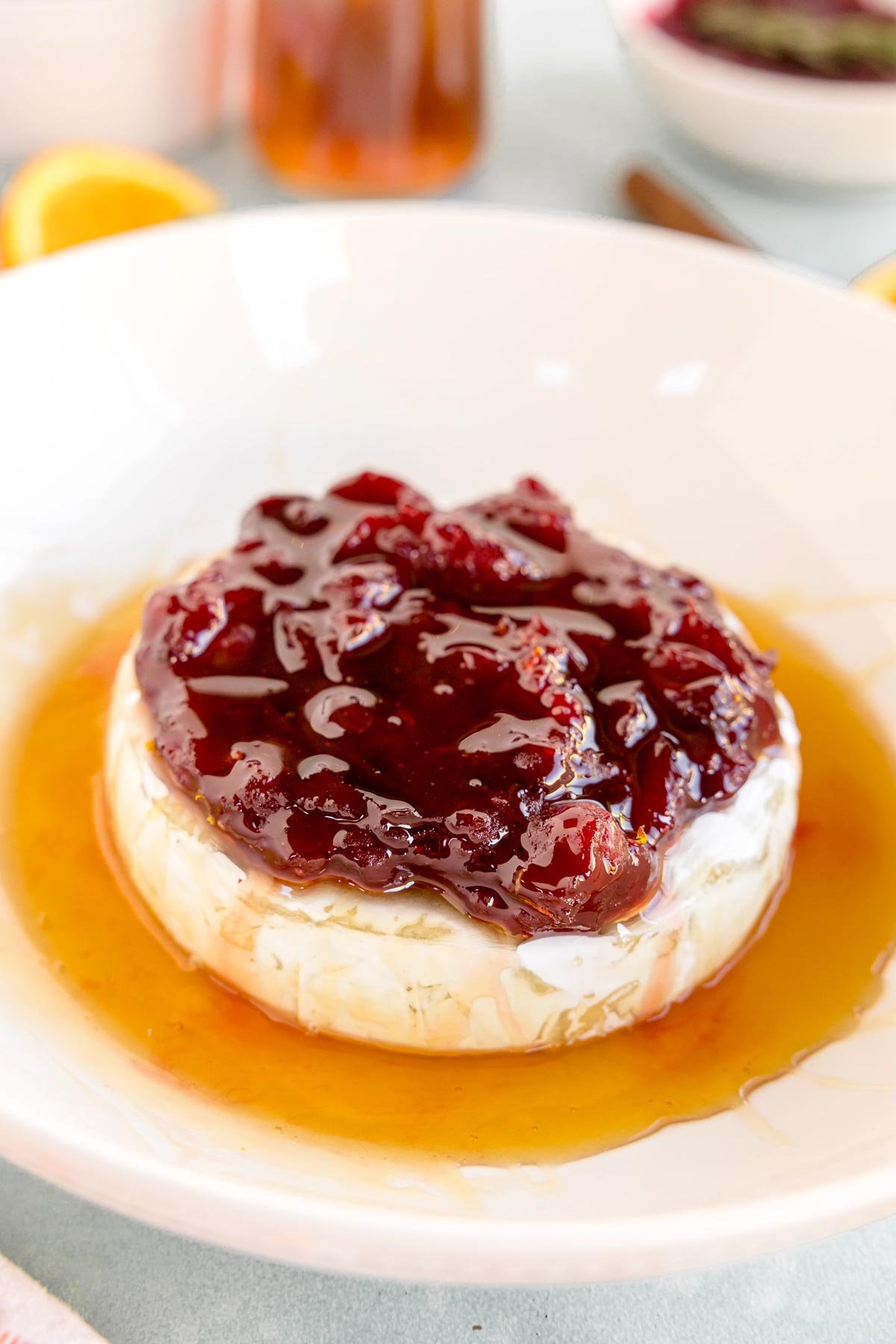 bake brie with honey topped with cranberry sauce