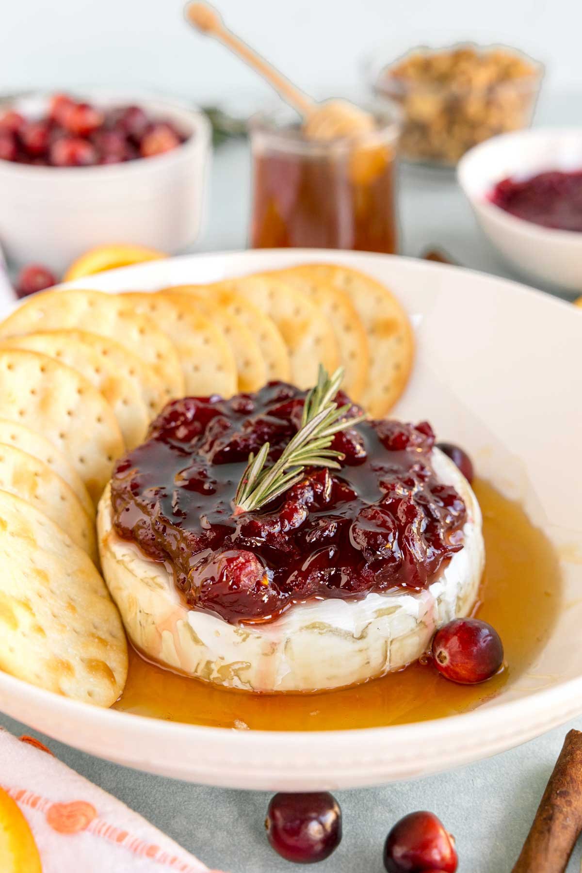 baked brie with crackers on a white plate