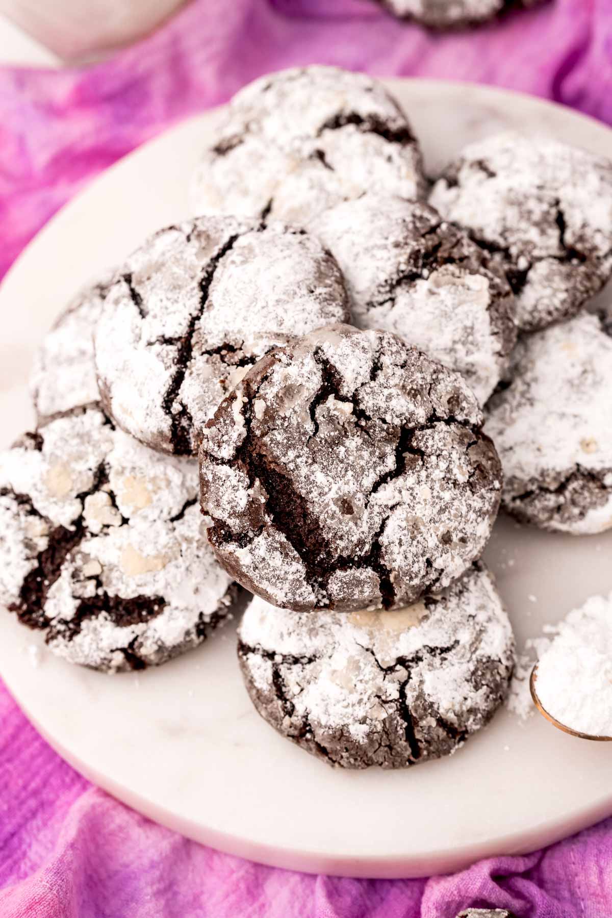 white plate with dark chocolate crinkle cookies