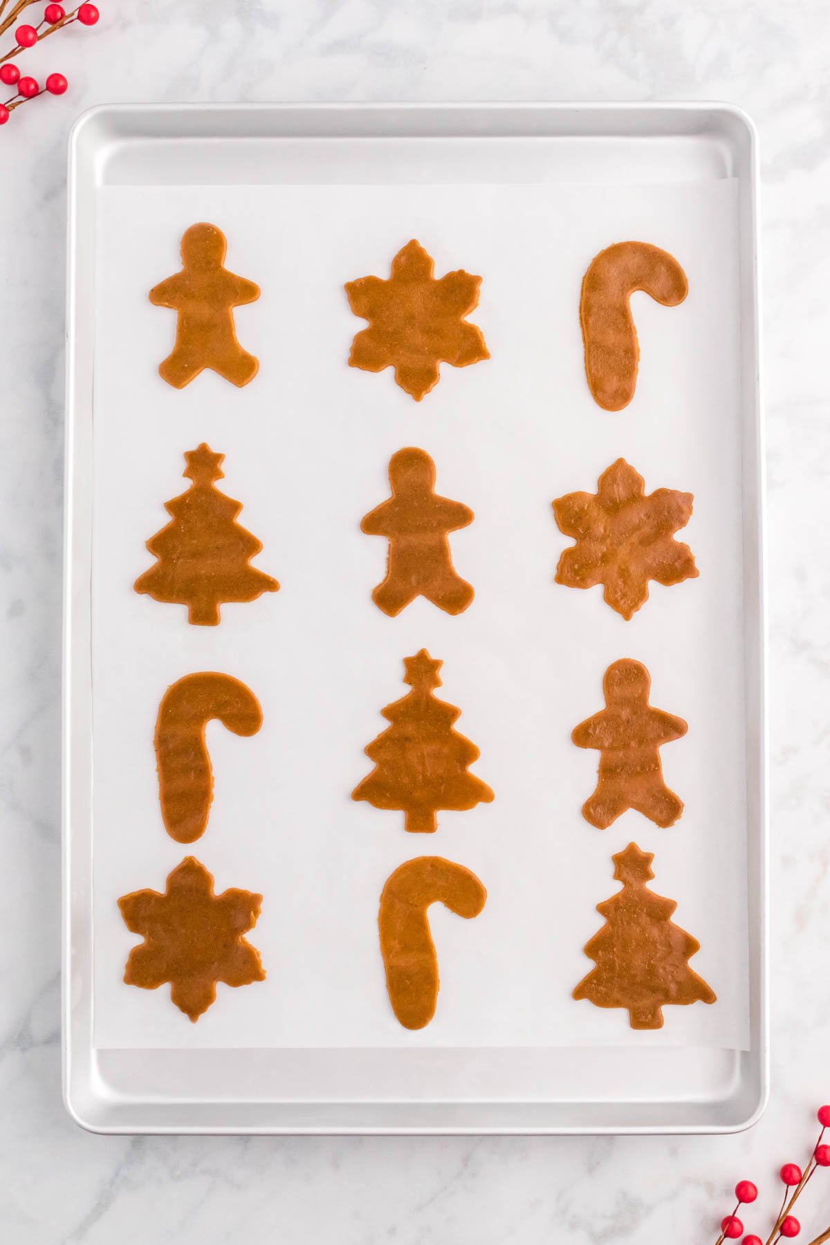 baking sheet with unbaked gingerbread cookies on it