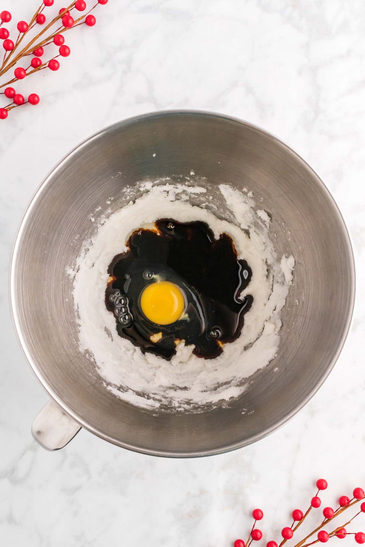 metal mixing bowl with molasses and egg 