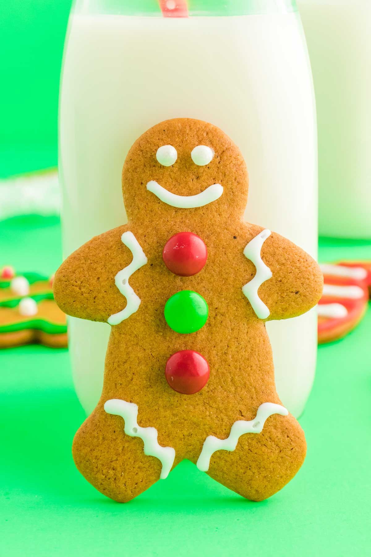 gingerbread cookie leaning against a glass of white milk