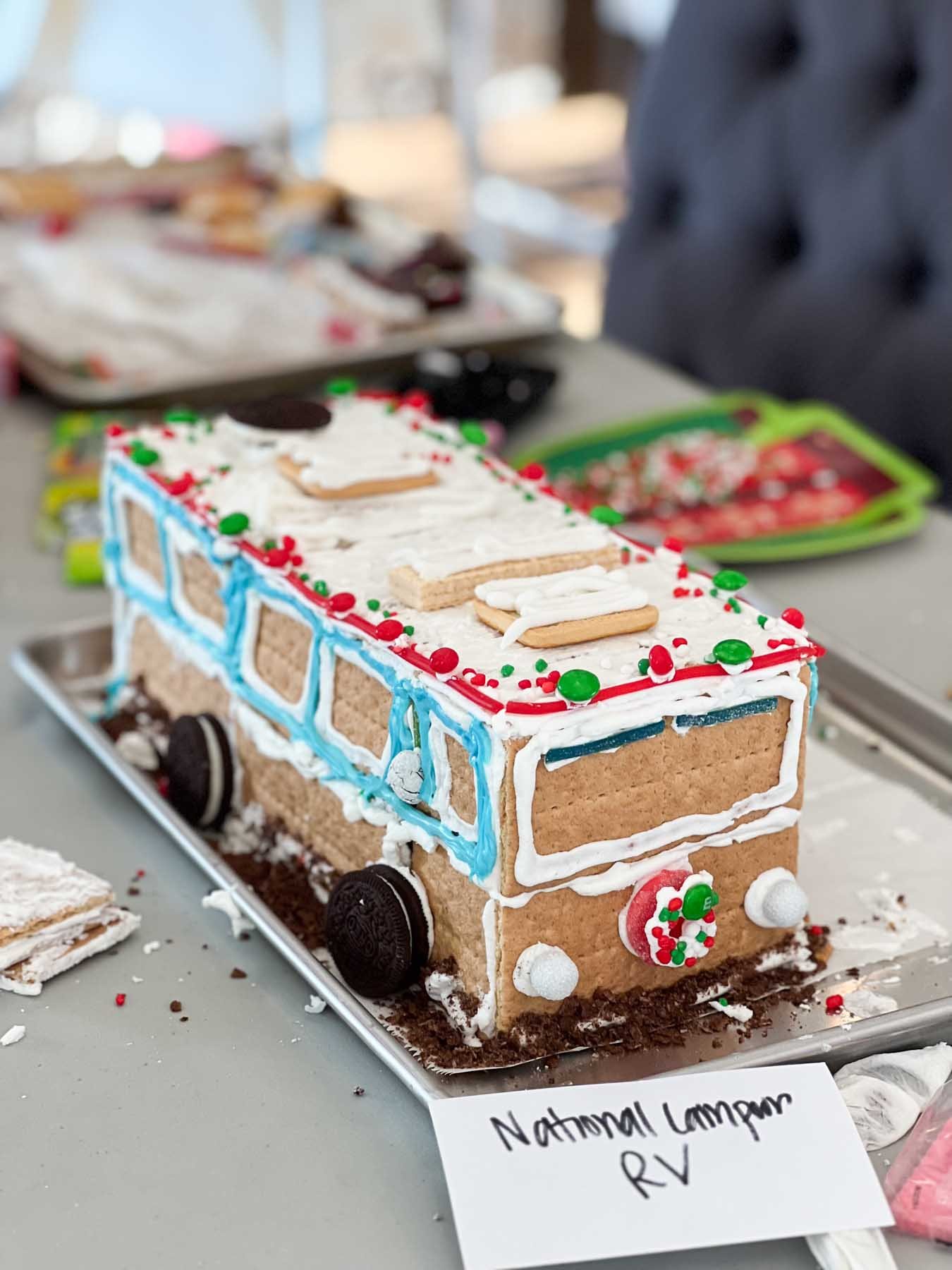 gingerbread RV with a white sign that says National Lampoon's vacation