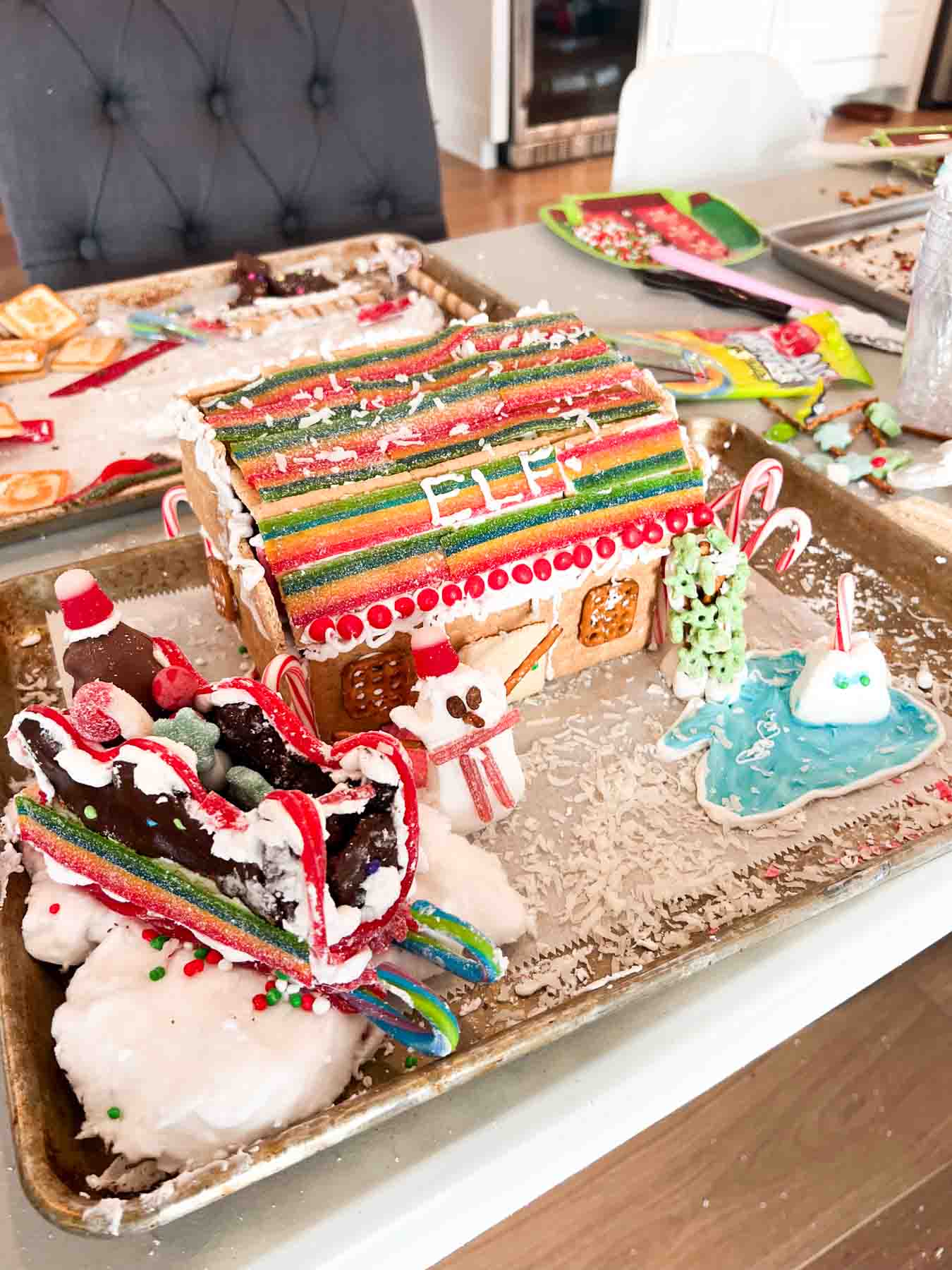 elf gingerbread house on a cookie sheet