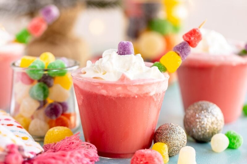 three glasses of gumdrop punch with gumdrop garnishes